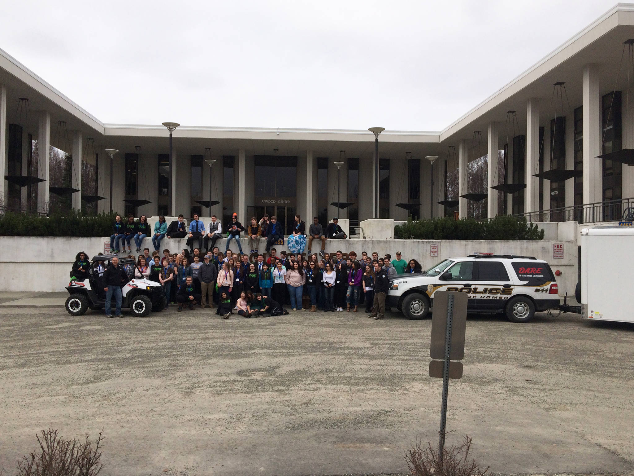Sgt. Ryan Browning and Officer Jim Knott pose with teenagers at the State Youth Court Conference in summer 2015 in Anchorage, Alaska. The Homer Police Department has been invited to travel around the state to share its Project Drive, and anti-drunk driving educational clinic in place since 2011. (Photo courtesy Ryan Browning)
