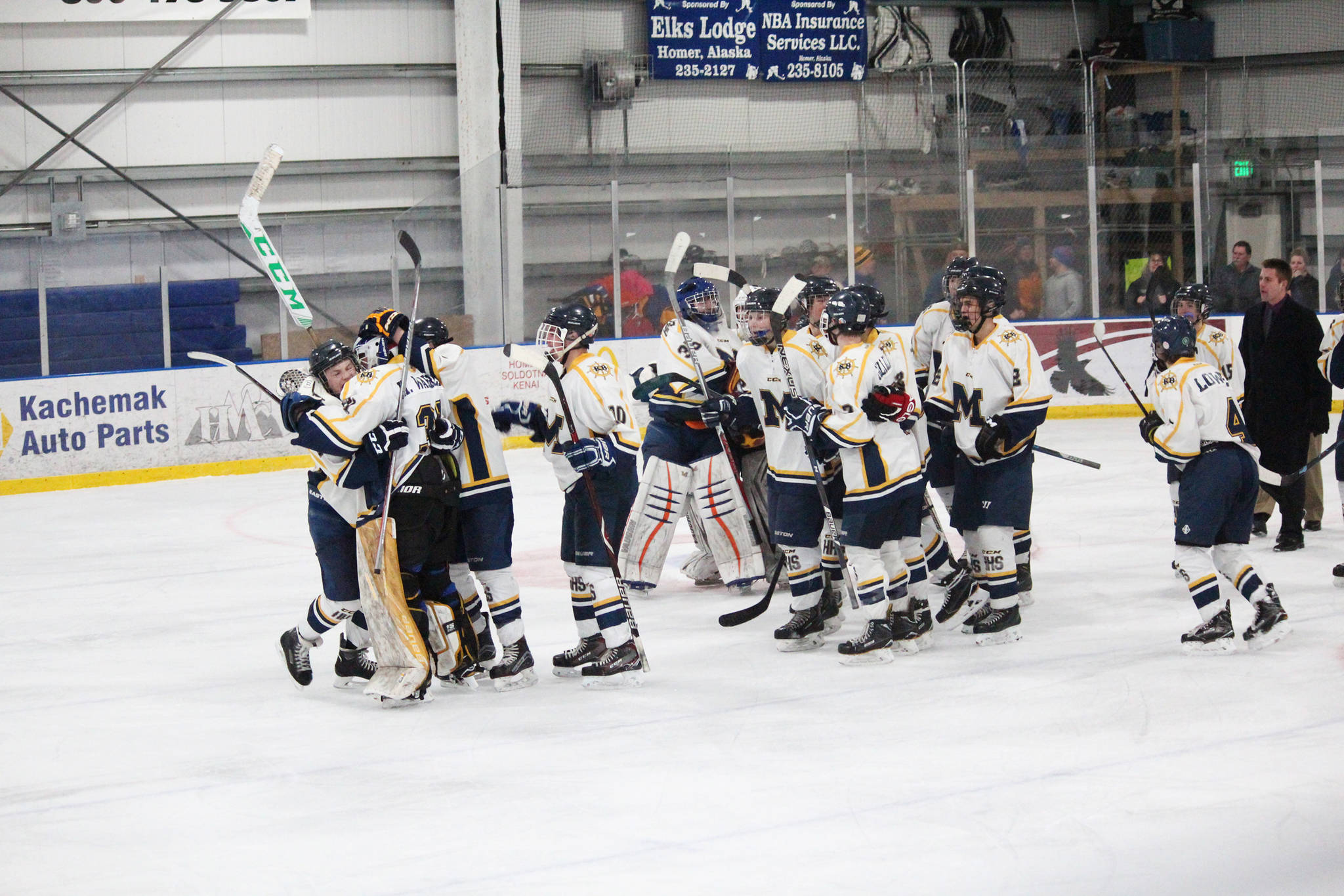 Homer High School’s hockey team celebrates its 2-1 win against Colony High School on Friday, Dec. 1, 2017 at Kevin Bell Arena in Homer, Alaska. Homer’s Ethan Pitzman scored the winning goal with less than 11 seconds left on the clock in overtime. The Mariners swept all three Mat-Su Valley teams they played this weekend, moving to 3-0 in conference play. (Photo by Megan Pacer/Homer News)