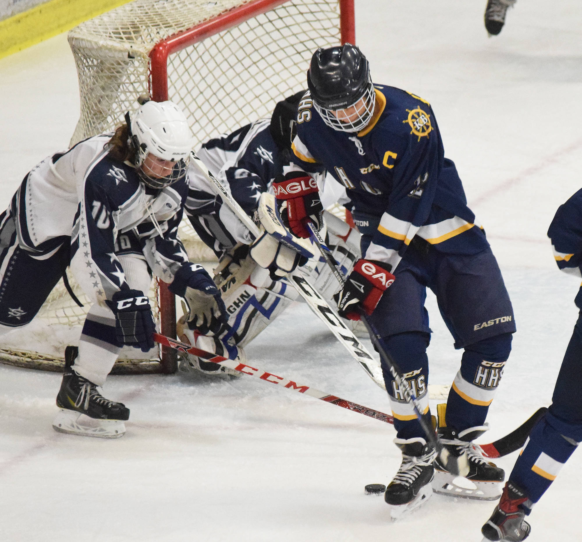 Homer’s Dimitry Kuzmin (front) works for a shot against Soldotna goaltender Kenzie Powell Tuesday, Dec. 5, 2017 at the Soldotna Regional Sports Complex in Soldotna, Alaska. (Photo by Joey Klecka/Peninsula Clarion)