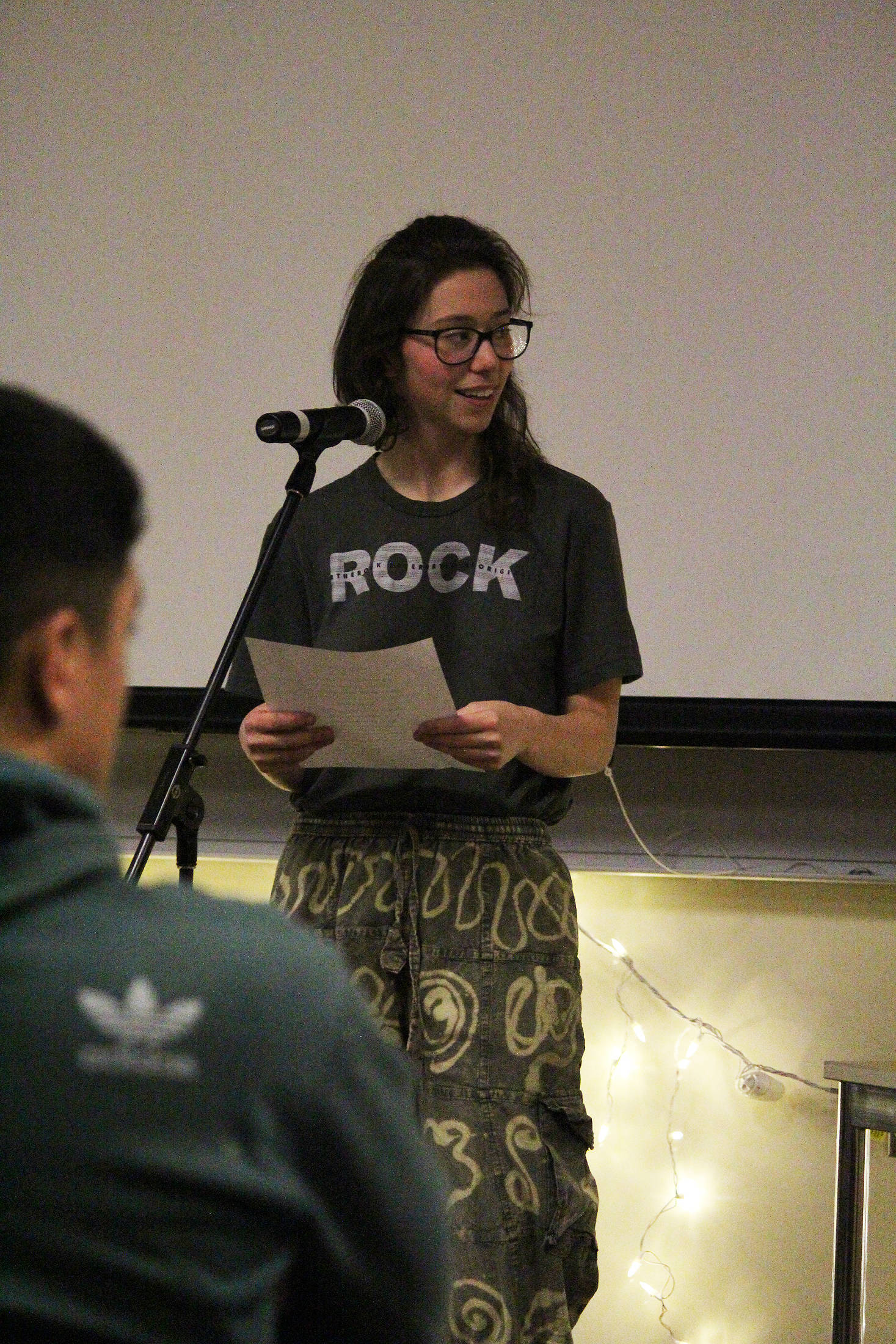 Homer Flex student Zoe Kramer, 17, reads a sonnet she wrote during a Coffee House event held Tuesday, Dec. 5, 2017 at Pioneer Hall on Kachemak Bay Campus in Homer, Alaska. Hosted by the campus Student Association, the Coffee House provided an opportunity for students, many of whom were in a creative writing class at the college, to share their poems, short stories and essays in public. (Photo by Megan Pacer/Homer News)