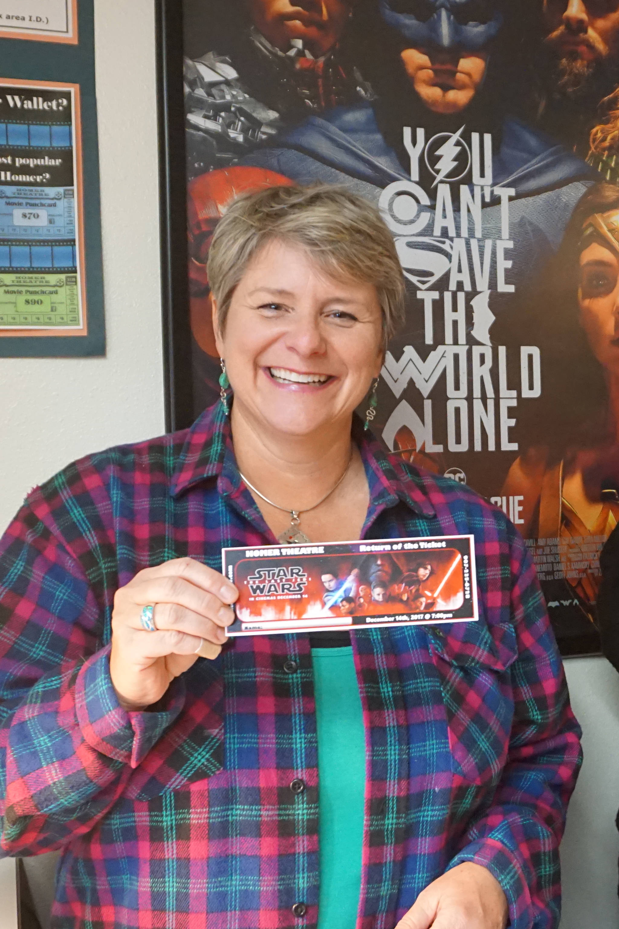 Homer Theatre manager Colleen Carroll holds up a ticket to the Homer premiere of “Star Wars: The Last Jedi” after tickets went on sale Saturday, Dec. 2, 2017 at the theatre in Homer, Alaska. The gala opening night is Dec. 14. (Photo by Michael Armstrong, Homer News)