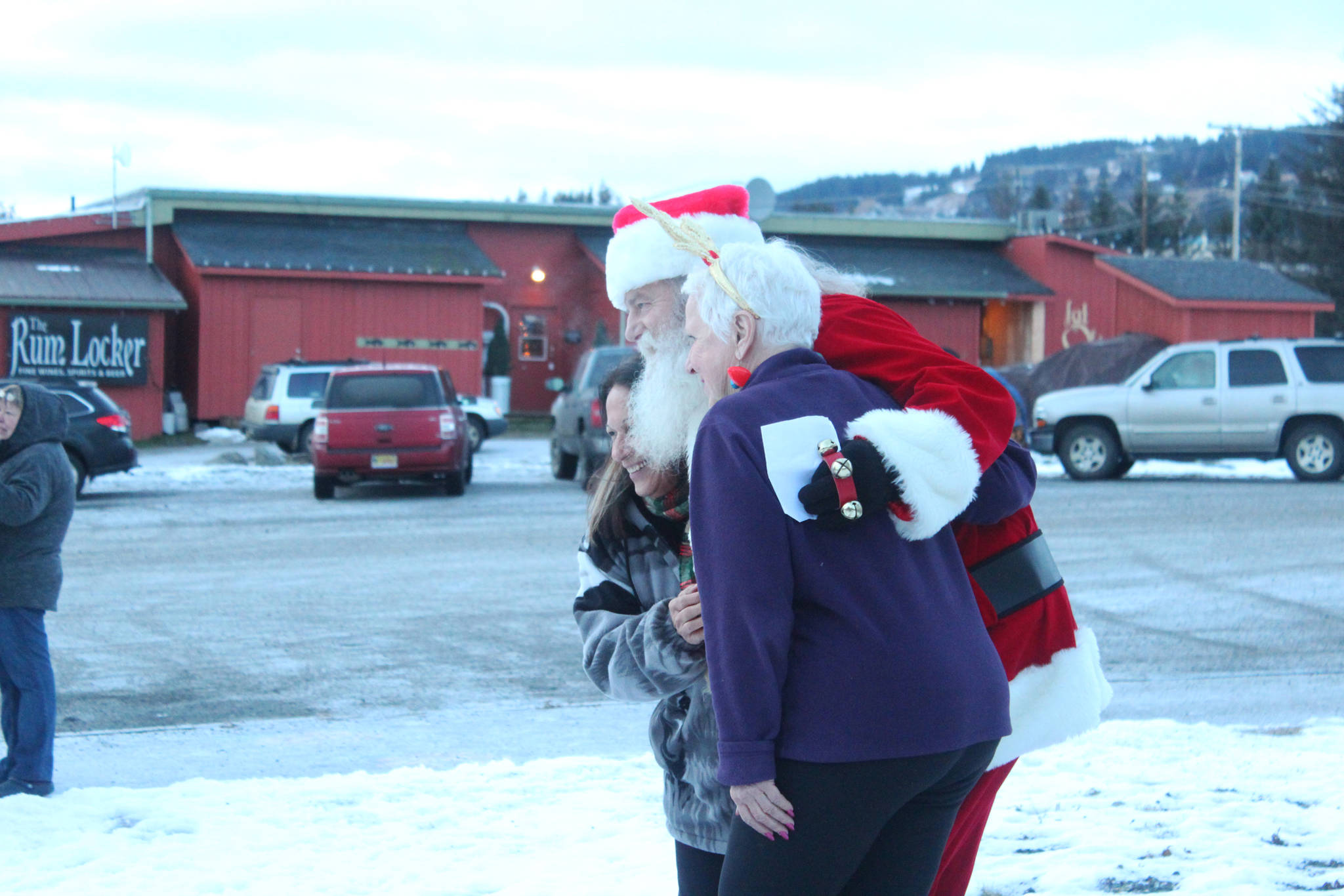 Anchor Point resident Dennis Dustin poses as Santa Clause with attendees of the Homer Chamber of Commerce holiday tree lighting event Friday, Dec. 1, 2017 in Homer, Alaska. Dustin and his wife, Marcella, have been volunteering as Mr. and Mrs. Clause since the Chamber event began. (Photo by Megan Pacer/Homer News)