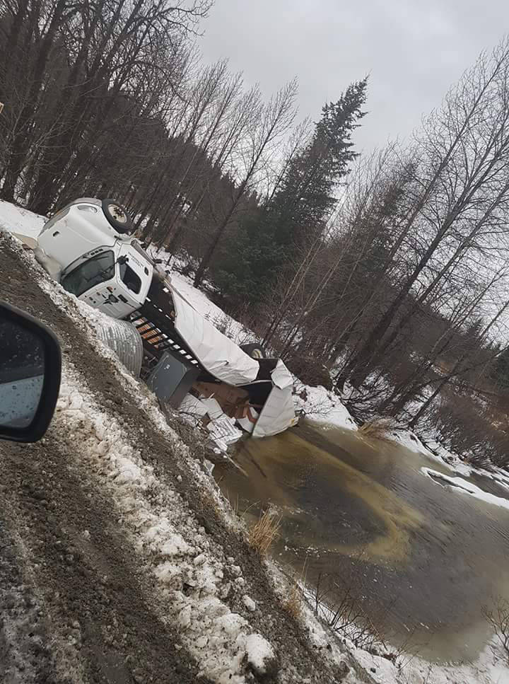 A photo provided by Cook Inletkeeper shows a Freightliner truck operated by AK Trucking that overturned on the Nikolaevsk Road near the North Fork of the Anchor River, Alaska. The crash spilled an estimated 15 gallons of fuel, according to the Alaska Department of Environmental Conservation. (Photo provided, Cook Inletkeeper)