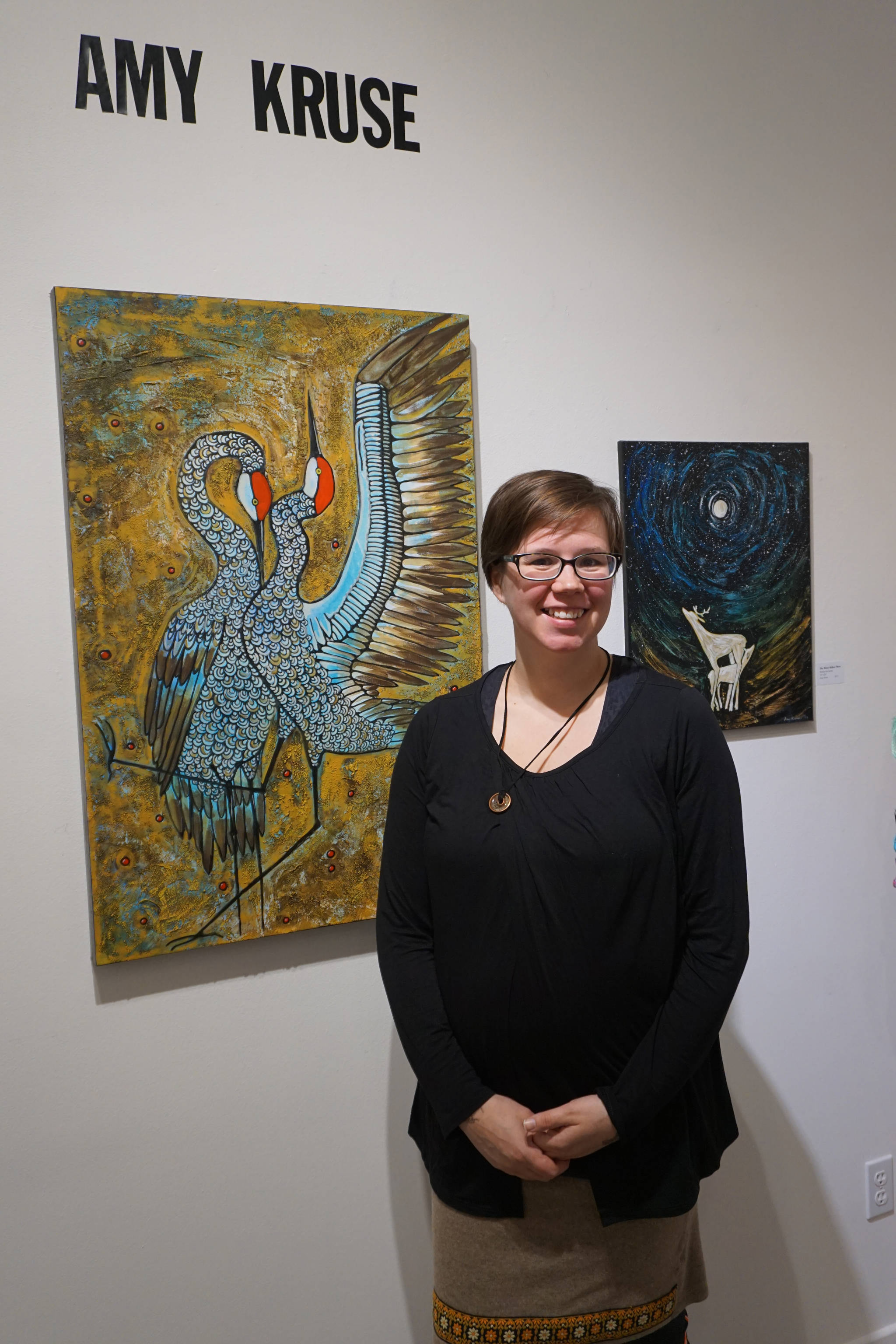 Amy Kruse poses for a photo at a First Friday reception on Dec. 1 2017 at Fireweed Gallery in Homer, Alaska. (Photo by Michael Armstrong, Homer News)