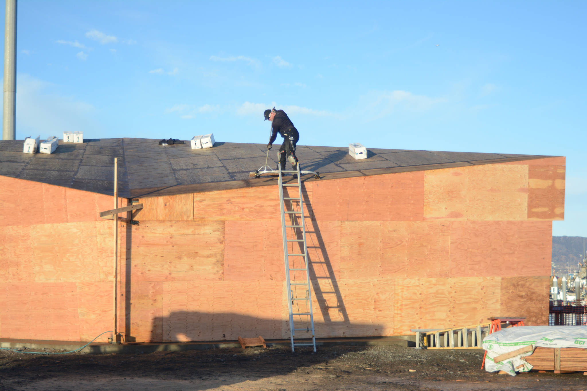 Photo by Michael Armstrong/Homer News Dave Louk of Last Frontier Roofing works last Friday on the roof of the new Boat House at the harbor near Ramp 2. The pavilion is under construction at the site of the old harbor office and when finished will provide shelter for harbor users.