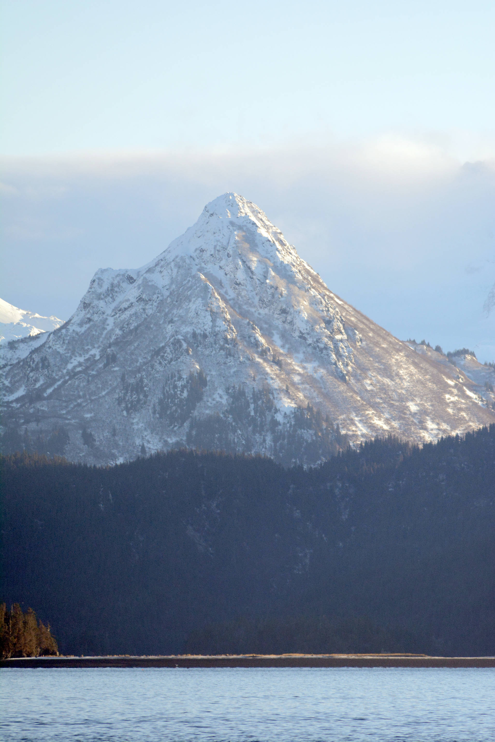 The bear in the side of Poot Peak has emerged for the winter after snow fell on the mountain Friday, Dec. 8, 2017 in Homer, Alaska, highlighting the image of of a head, nose and eyes. (Photo by Michael Armstrong, Homer News)