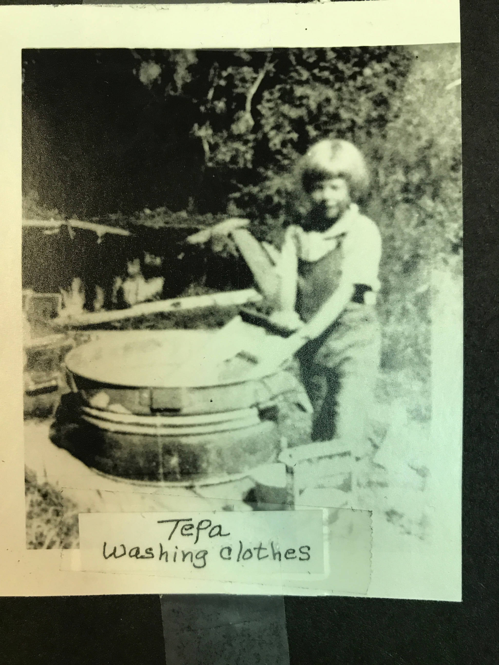 Tepa Rogers as a young girl washing clothes in a tub with a washboard. (Photo provided)