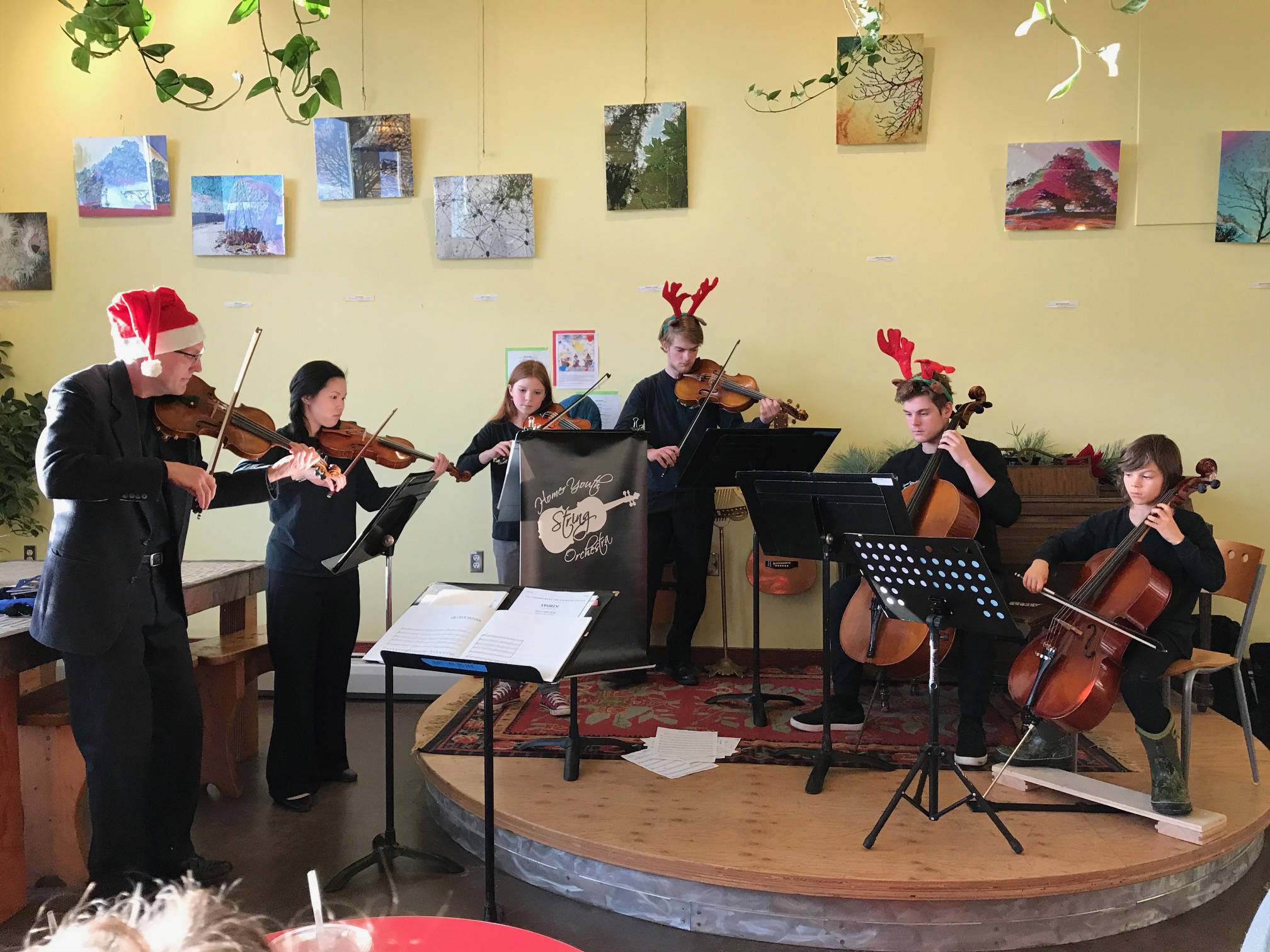 Members of the Homer Youth String Orchestra perform spread some holiday cheer at K-Bay Caffé on Saturday, Dec. 16, 2017 in Homer, Alaska. From left to right are Daniel Perry, Rosy Kauffman, Sylvia Clemens, Theodore Handley, Avram Salzmann and Clyde Clemens. (Photo provided)