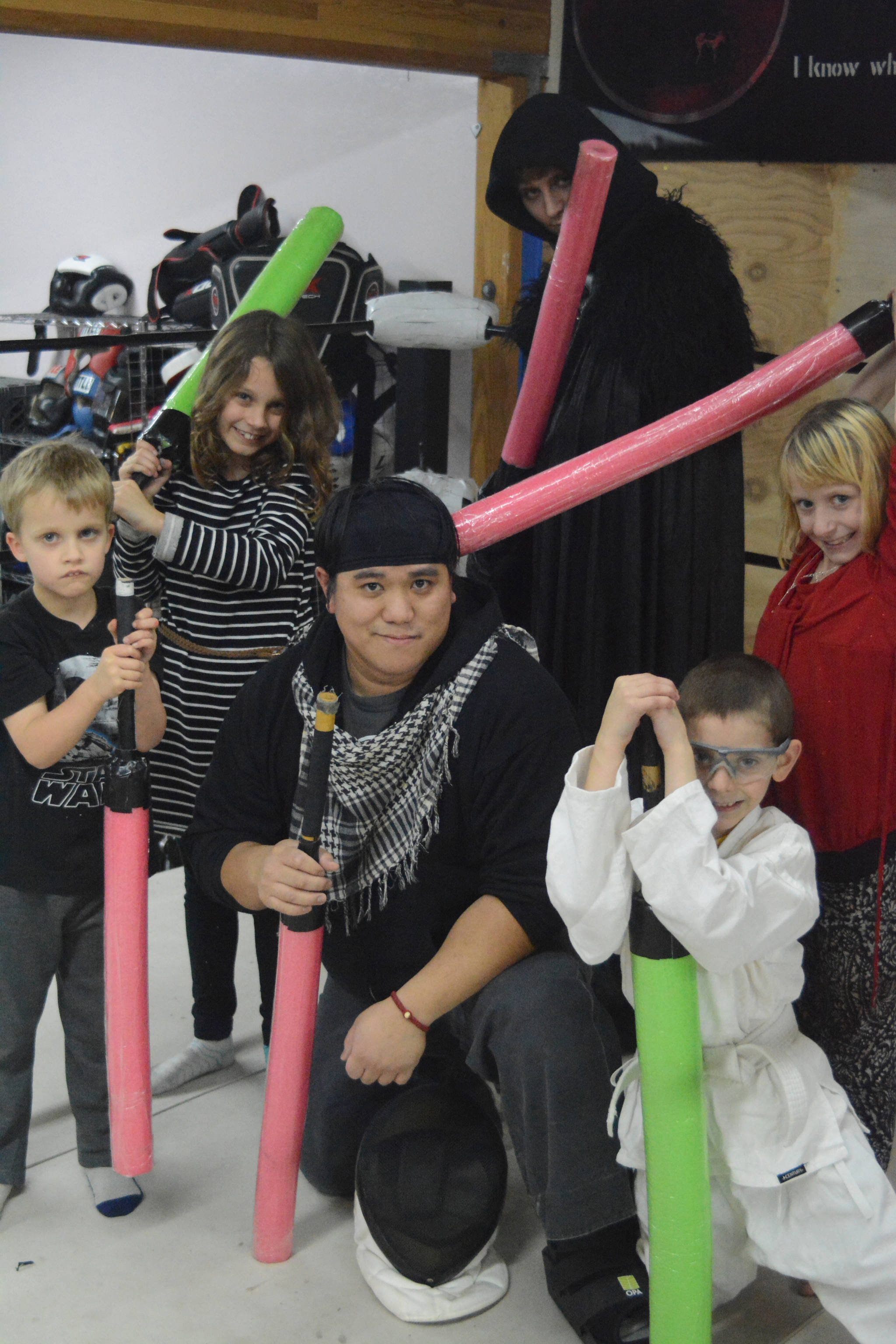 Students at K-Bay Martial Athletics get in the spirit of “Star Wars: The Last Jedi” on Dec. 19. They fought light saber battles with foam swords. From left to right, back, are Jim Richardson, Charlotte Richardson and Cooper Hyde; center, Guro Kurt P. Leffler II, Hayden Cox, second from right, and Alivia Craddock. K-Bay Martial Athletics offers an after-school program called Warriors and Scholars that teaches children martial arts but also values like politeness, respects and team work as well as weapons safety.