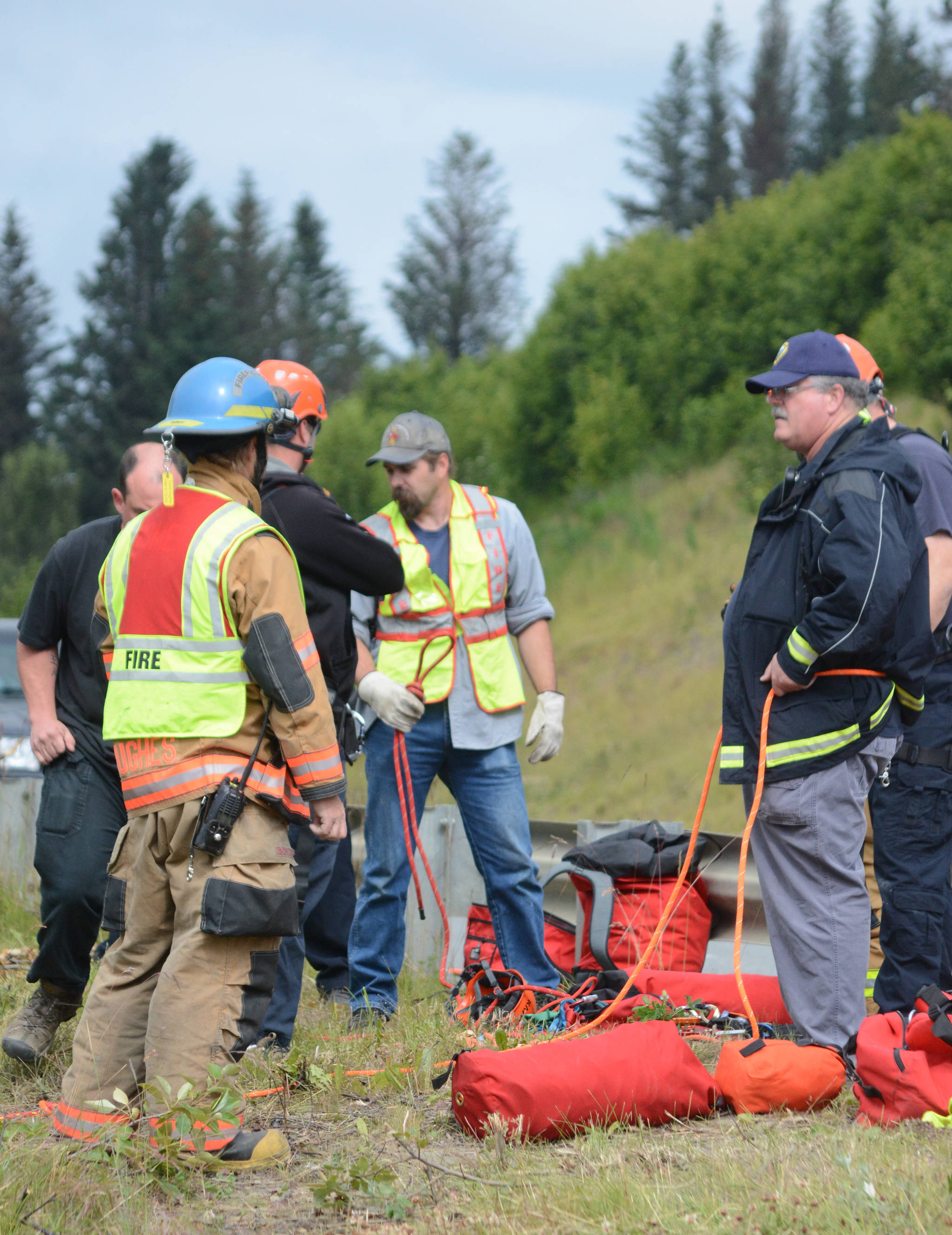Homer Volunteer Fire Department Chief Bob Painter, right, supervises a search for the victim of a truck plunge at Baycrest Hill in July 2017.
