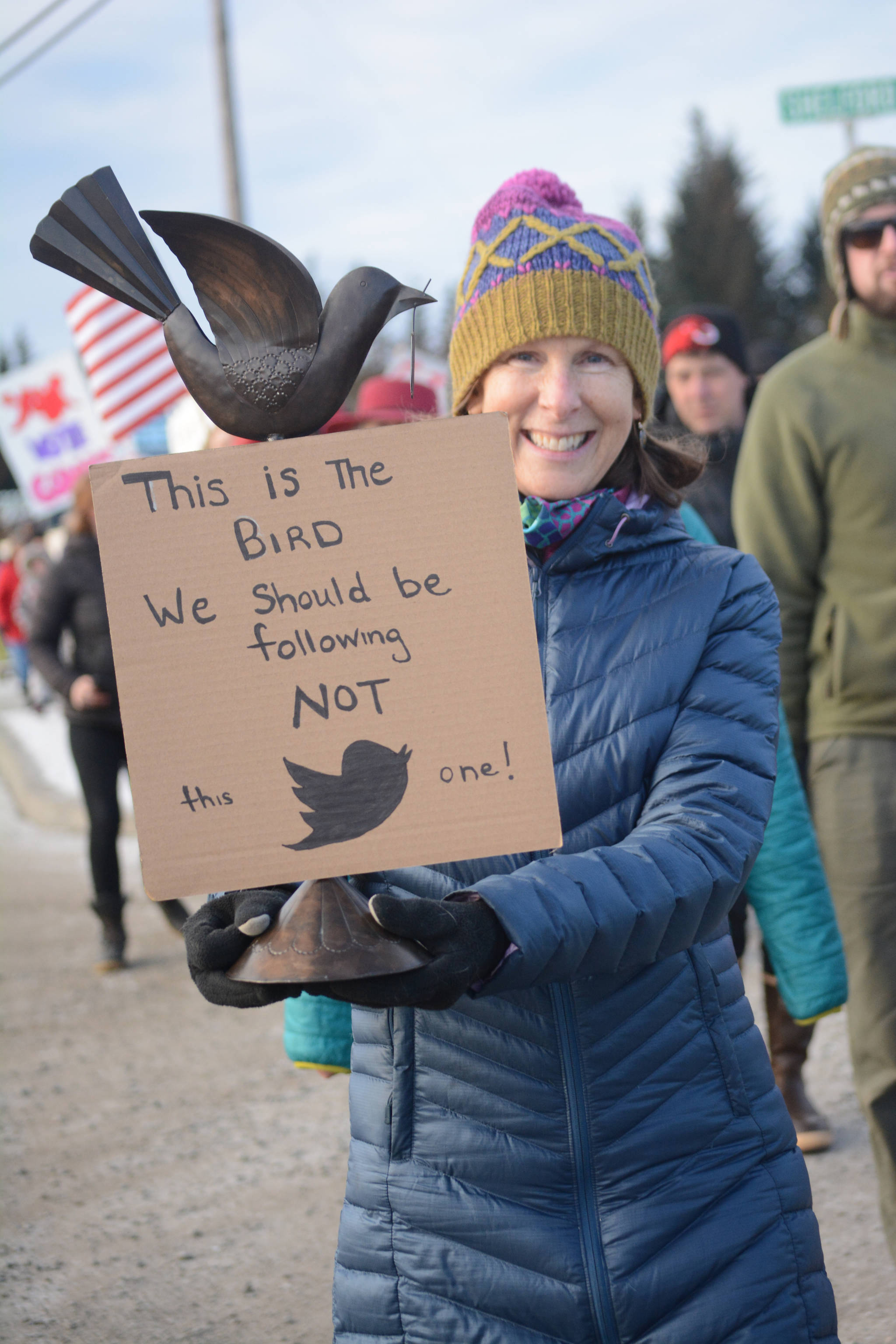 Sue Mauger holds a sign in the Homer March for Women on Saturday. About 700 people walked in the march along Pioneer Avenue on Jan. 20, 2018, in Homer, Alaska. The group of marchers extended from Main Street to Kachemak Way. (Photo by Michael Armstrong/Homer News)