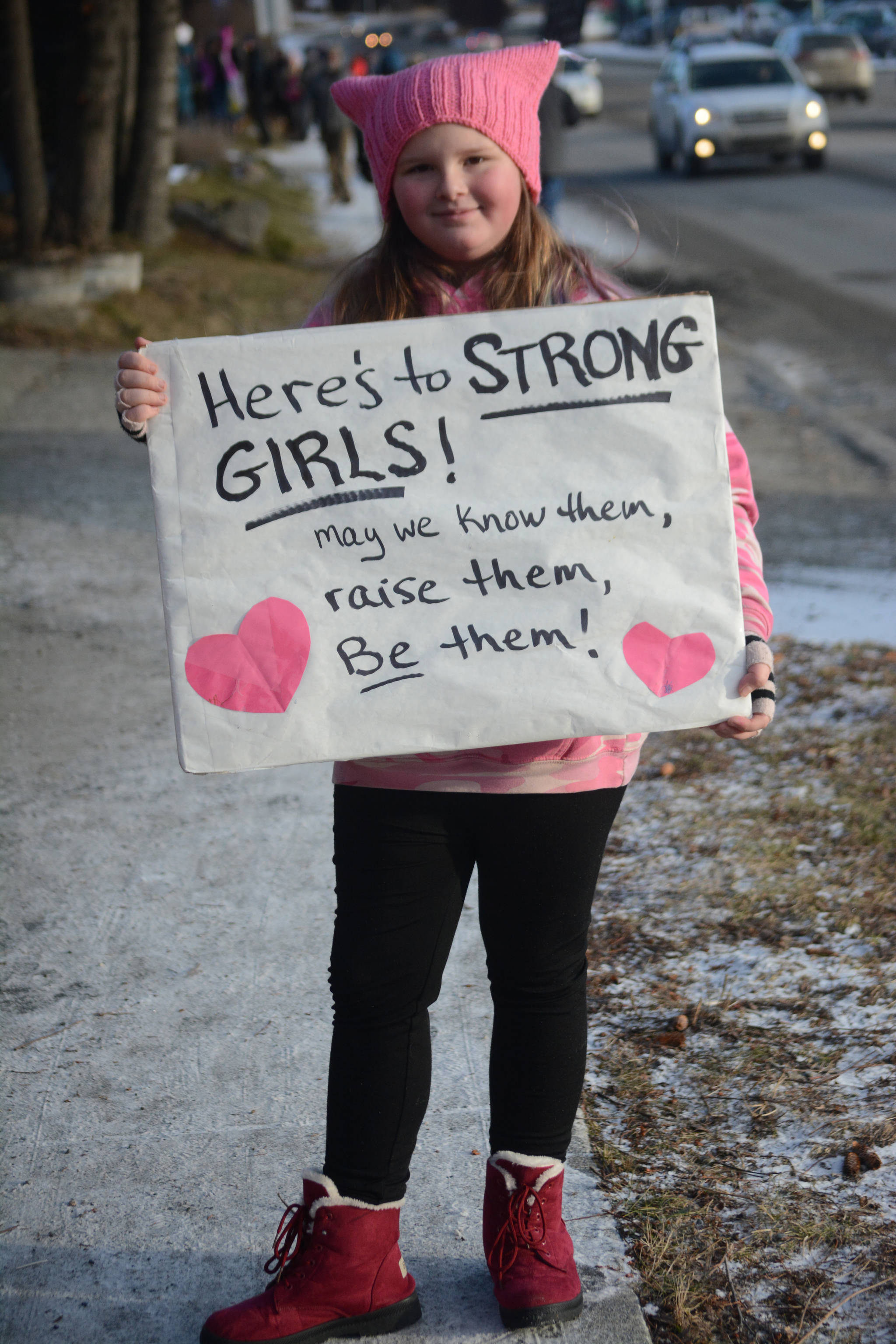 Hope Stearns holds a sign in the Homer March for Women on Saturday. About 700 people walked in the march along Pioneer Avenue on Jan. 20, 2018, in Homer, Alaska. The line of marchers extended from Main Street to Kachemak Way. (Photo by Michael Armstrong/Homer News)