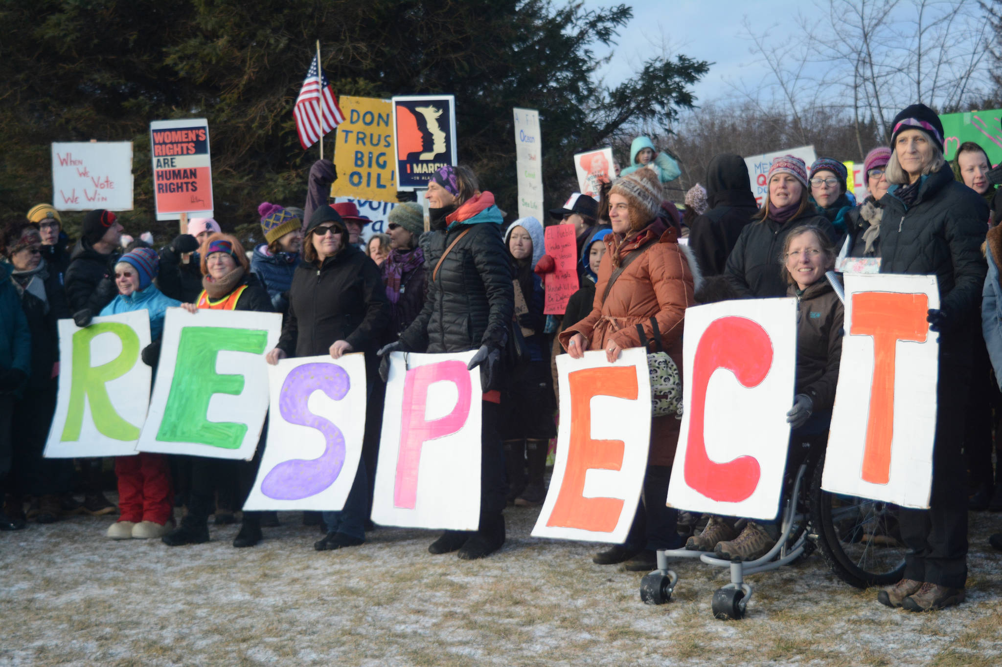Participants hold up letters that spell out ‘RESPECT” at WKFL Park at the end of the Homer March for Women on Saturday. About 700 people walked in the march along Pioneer Avenue on Jan. 20, 2018, in Homer, Alaska. The line of marchers extended from Main Street to Kachemak Way. (Photo by Michael Armstrong/Homer News)