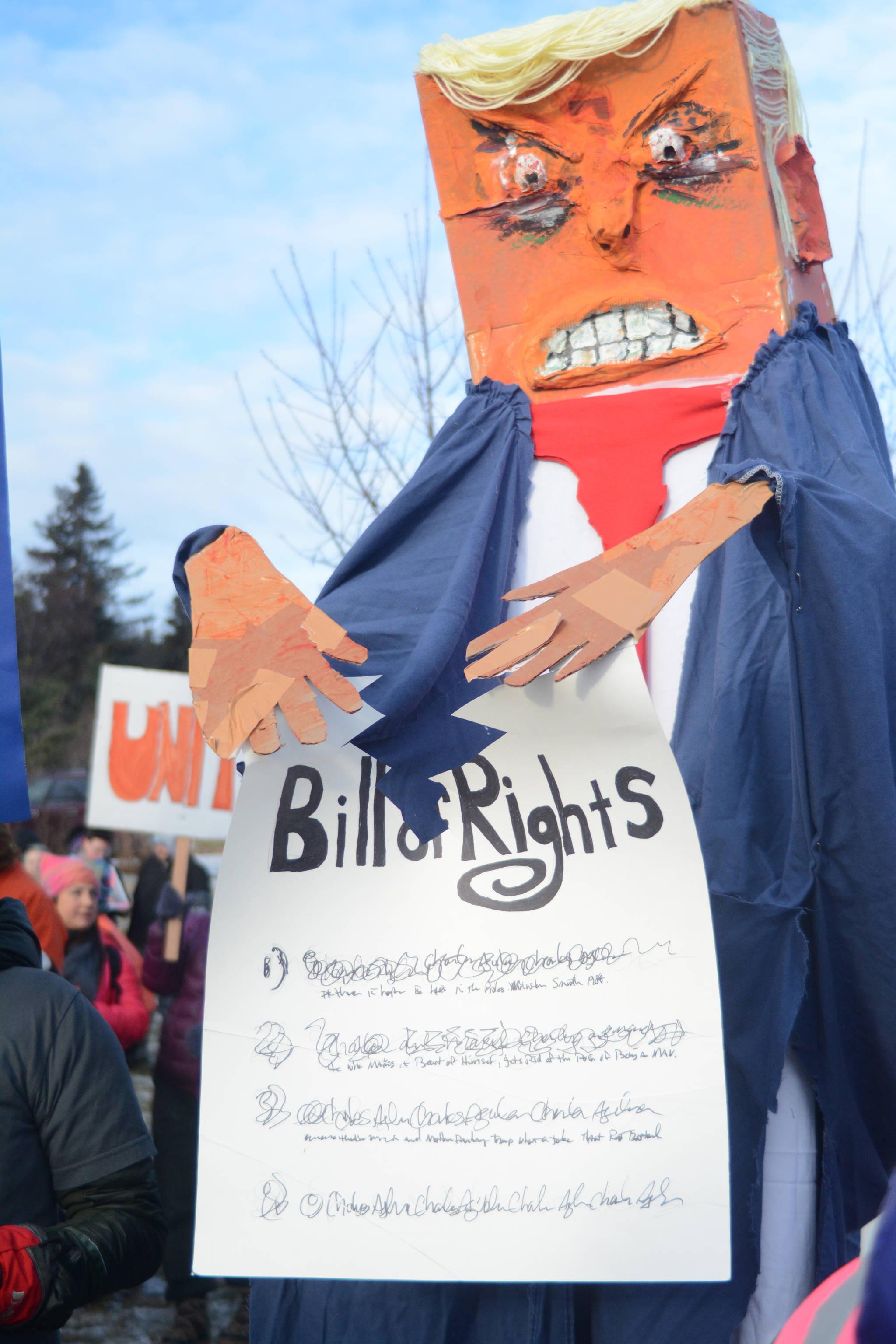 A President Donald Trump puppet shreds the Bill of Rights in the Homer March for Women on Saturday. About 700 people walked in the march along Pioneer Avenue on Jan. 20, 2018, in Homer, Alaska. The line of marchers extended from Main Street to Kachemak Way. (Photo by Michael Armstrong/Homer News)