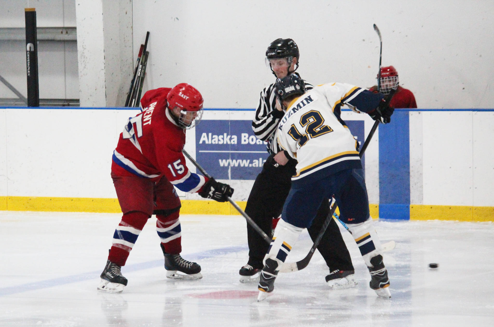 Homer senior Dimitry Kuzmin faces off against East Anchorage High School’s Devon Ament during their game Saturday, Jan. 20, 2018 at the Kevin Bell Arena in Homer, Alaska. The Mariners beat East, whose team was missing four players, 10-1. (Photo by Megan Pacer/Homer News)