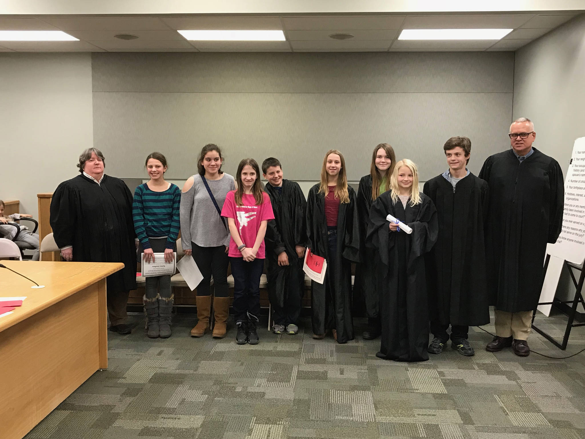 New judges and attorneys for the West Homer Elementary School / Fireweed Academy Youth Court pose after induction ceremonies at the Homer Courthouse on Monday, Jan. 22, 2018. Homer Disctrict Court Judge Margaret Murphy, far left, and Kenai Superior Court Judge Charles Huguelet, far right, administered the oaths of office. (Photo provided)