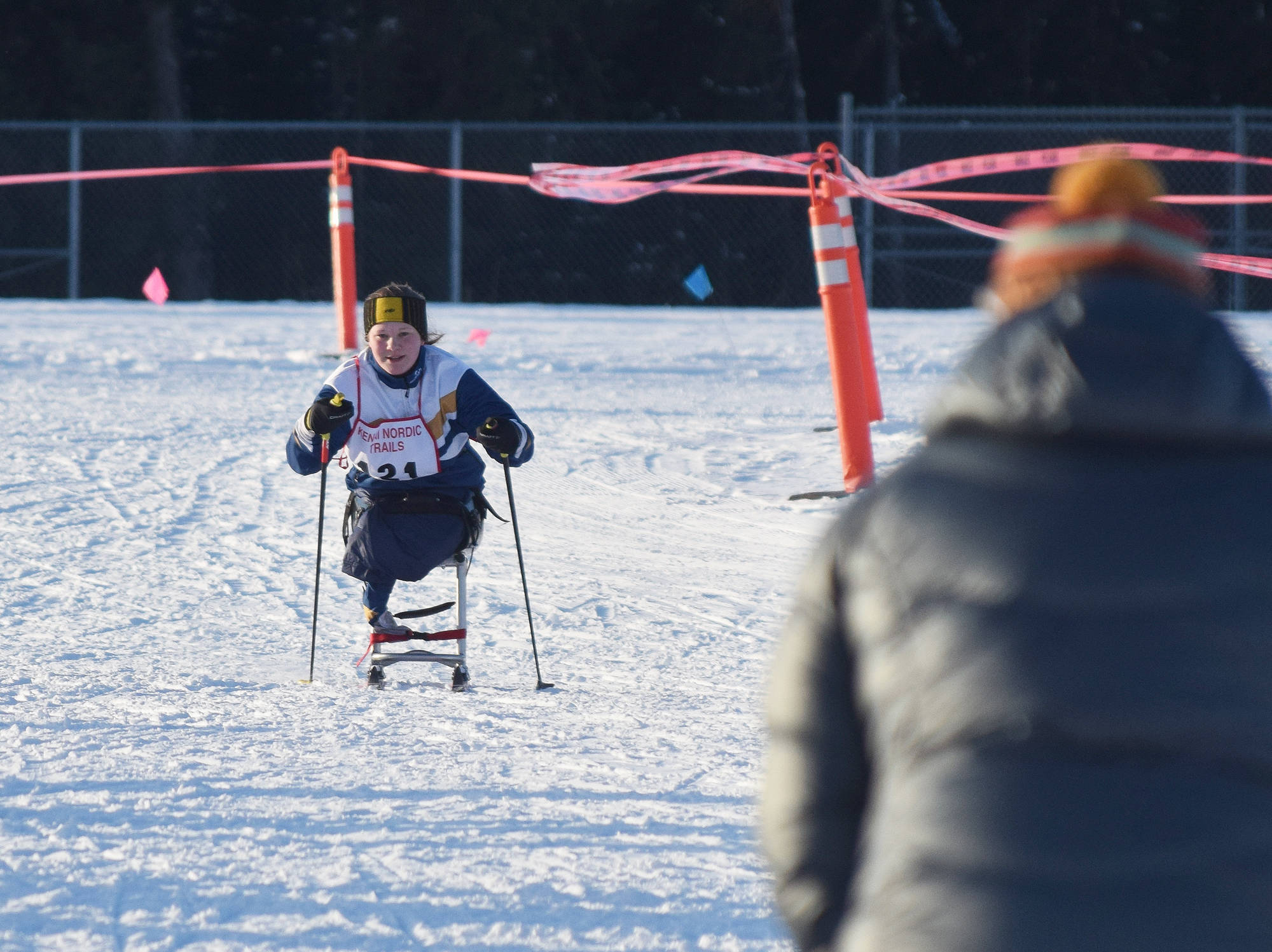 Angelica Haakenson of Homer approaches the finish line to cheers Friday, Jan. 26, 2018 in the Kenai Klassic races at the Tsalteshi Trails in Soldotna, Alaska. (Photo by Joey Klecka/Peninsula Clarion)