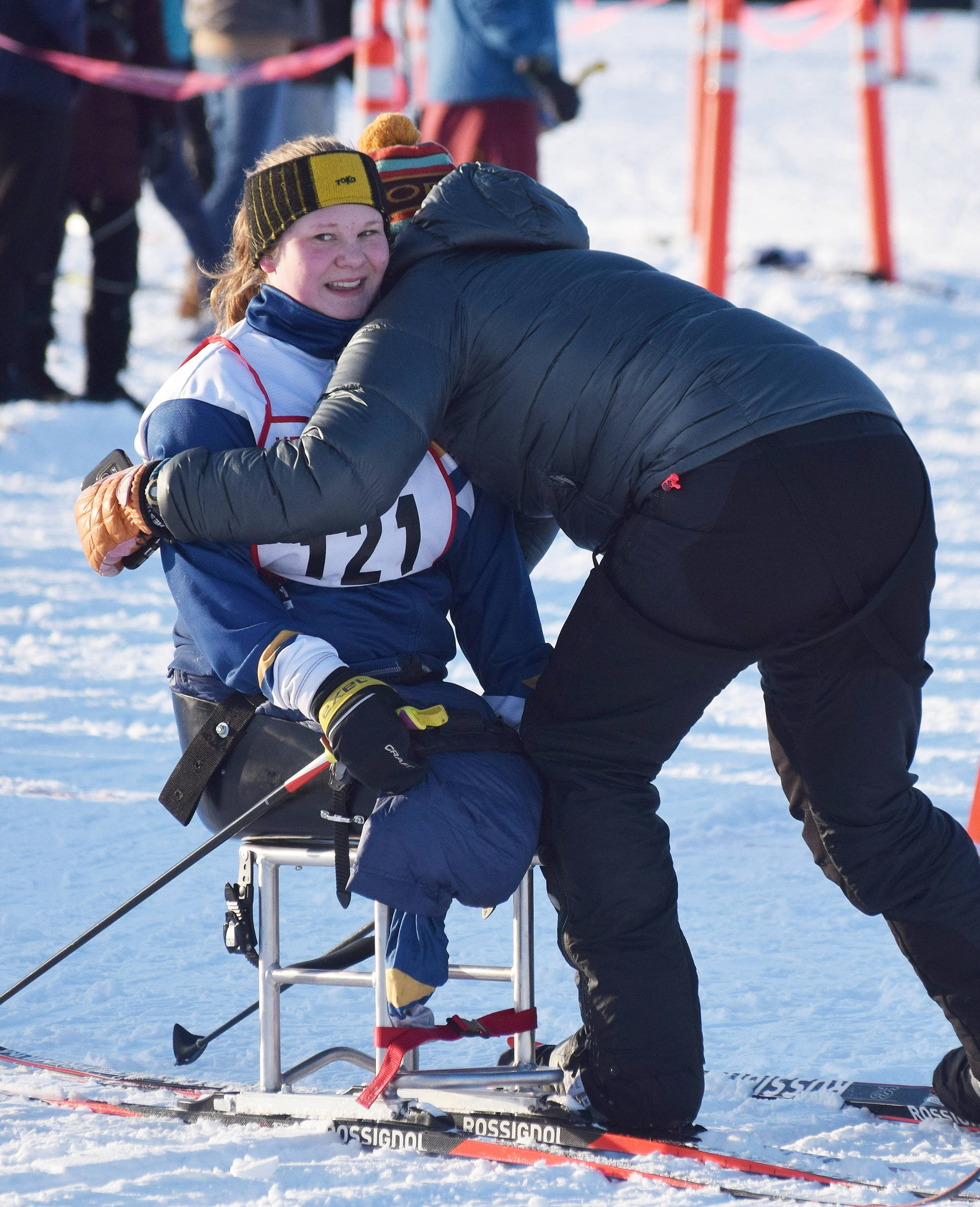 Angelica Haakenson receives a hug from Homer assistant coach Megan Corazza Friday afternoon in the Kenai Klassic races at the Tsalteshi Trails in Soldotna. (Photo by Joey Klecka/Peninsula Clarion)