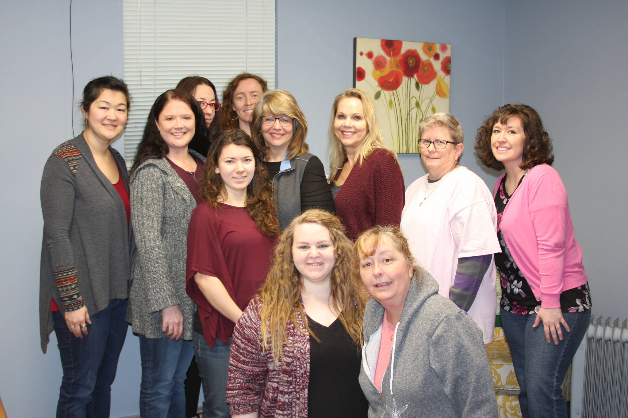 South Peninsula Haven House staff gather together at the Haven House facility on Lake Street in Homer, Alaska, on Monday, Jan.22, 2018. From left to right, front row, are Danielle Kline, Elizabeth Doan; back row, left to right, Lindsey Collins, Angie Cramer, Jenna Kropf, Leslie Scroggin, Carolyn Westbrook, Maggie Lush, Ronnie Leach, Mary Jo Gates and Carla Carrico. (Photo by Delcenia Cosman)