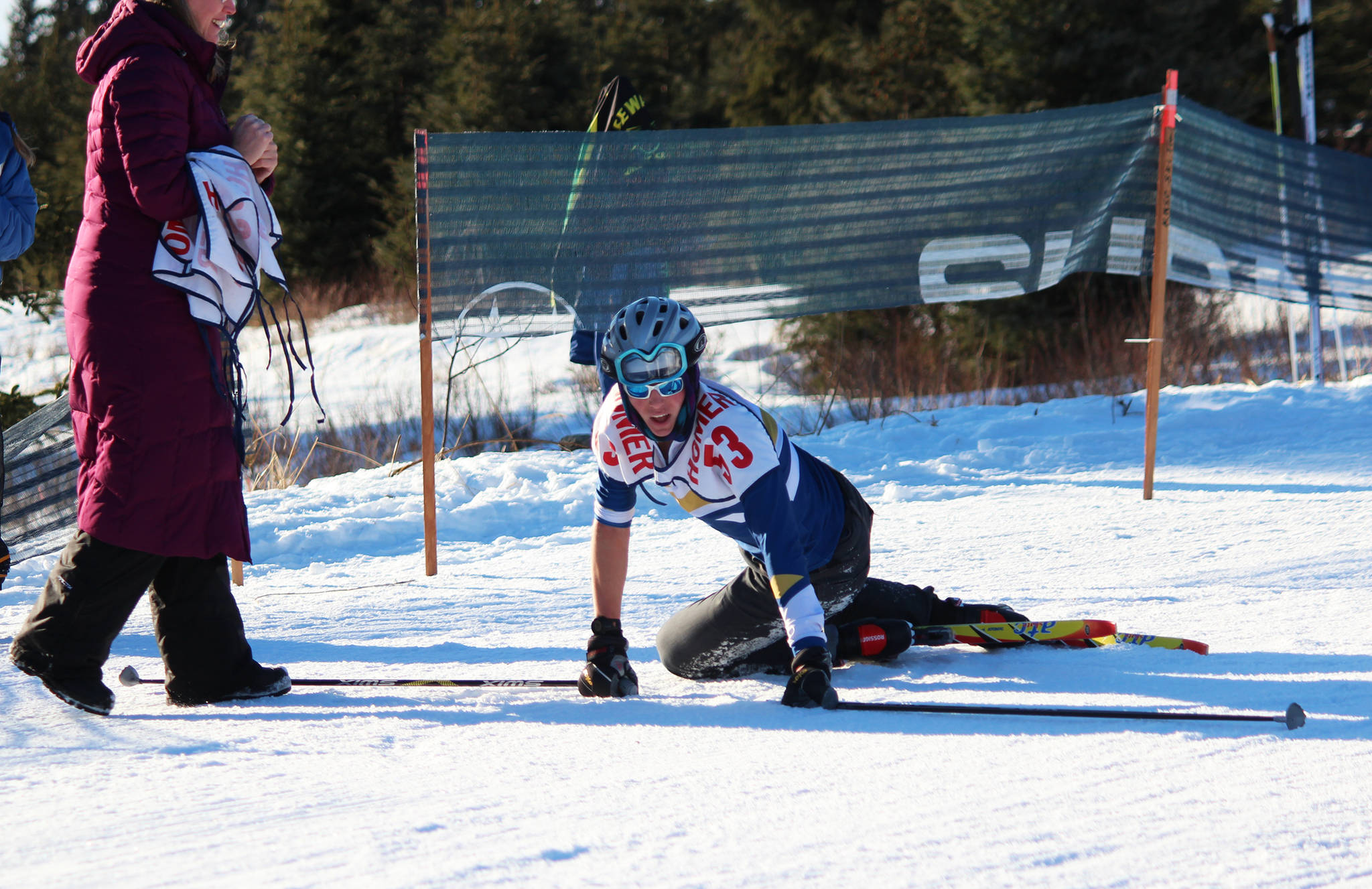 Homer’s Denver Waclawski stands back up after sliding to the ground when he crossed the finish line of the varsity boys’ 5 kilometer skate ski race Saturday, Feb. 3, 2018 at the Lookout Mountain Ski Trails near Homer, Alaska. Waclawski raced Soldotna’s Jode Sparks to a photo finish to claim sixth place. (Photo by Megan Pacer/Homer News)