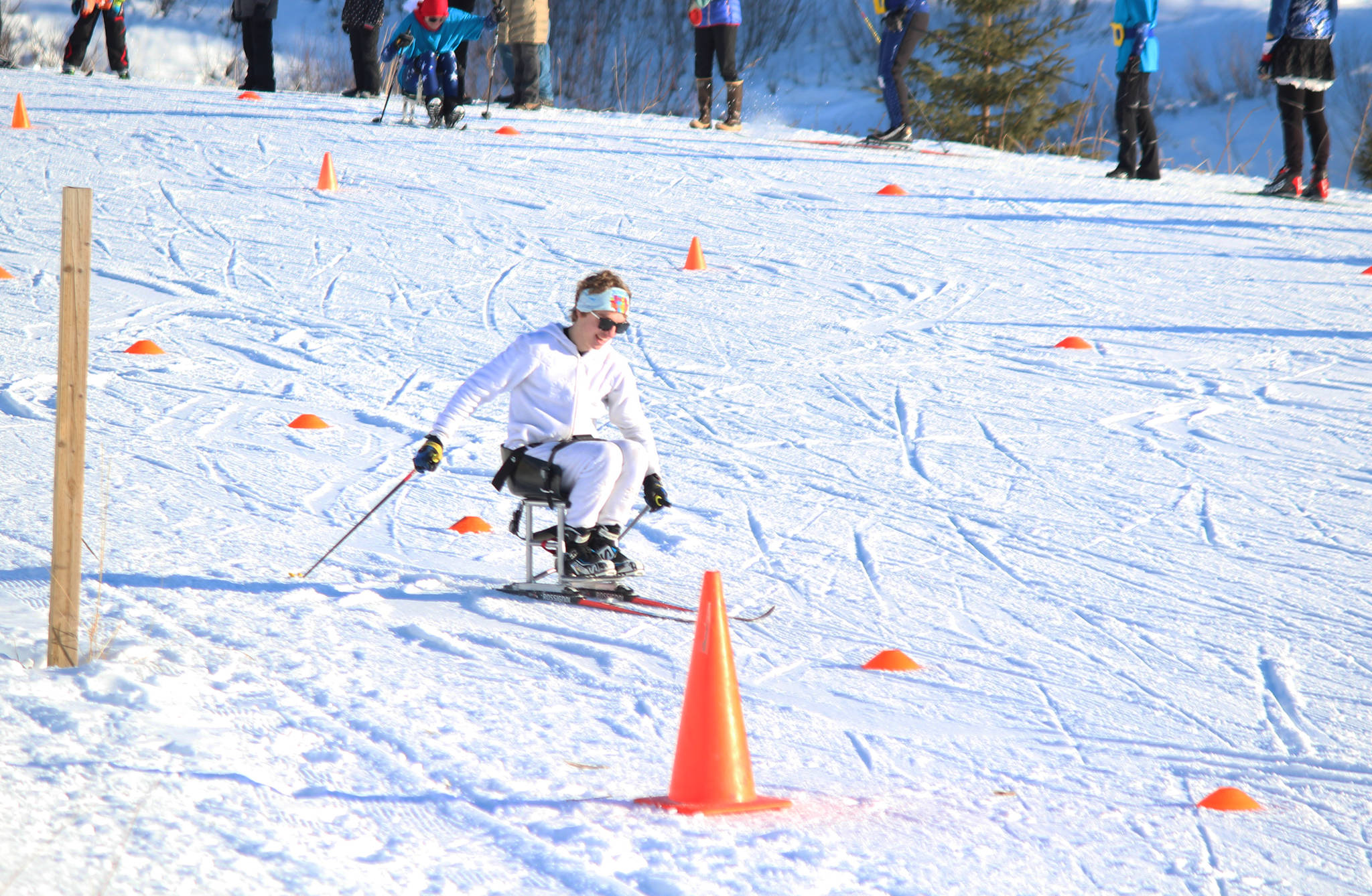 Homer’s Jacob Davis maneuvers around orange cones during the first leg of the adaptive sit ski relay race Saturday, Feb. 3, 2018 at the Lookout Mountain Ski Trails. Teams from Homer, Kenai and Soldotna raced teams of four (two standing skiers and two sit skiers) in the relay after the individual 5-kilometer skate races. (Photo by Megan Pacer/Homer News)
