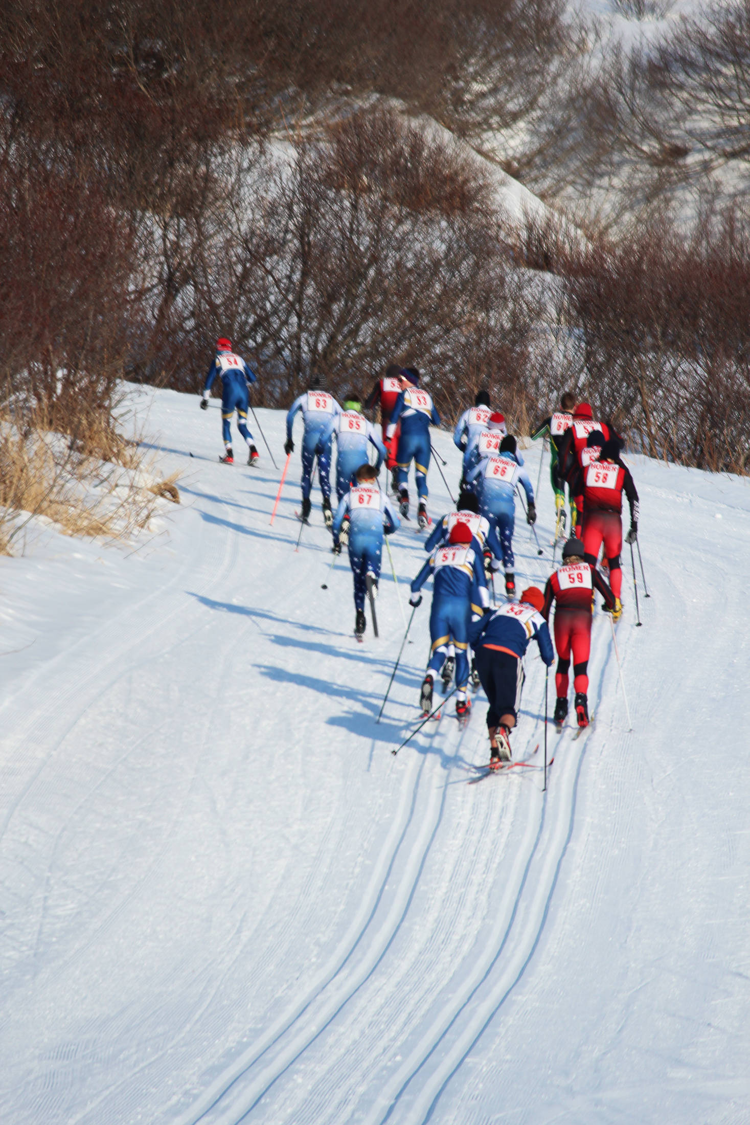 Skiers from Kenai Central High School, Soldotna High School, Homer High School and Seward High School take off up the first hill of the boys’ varsity 5 kilometer classic race Friday, Feb. 2, 2018 at an invitational at the Lookout Ski Trails near Homer, Alaska. (Photo by Megan Pacer/Homer News)