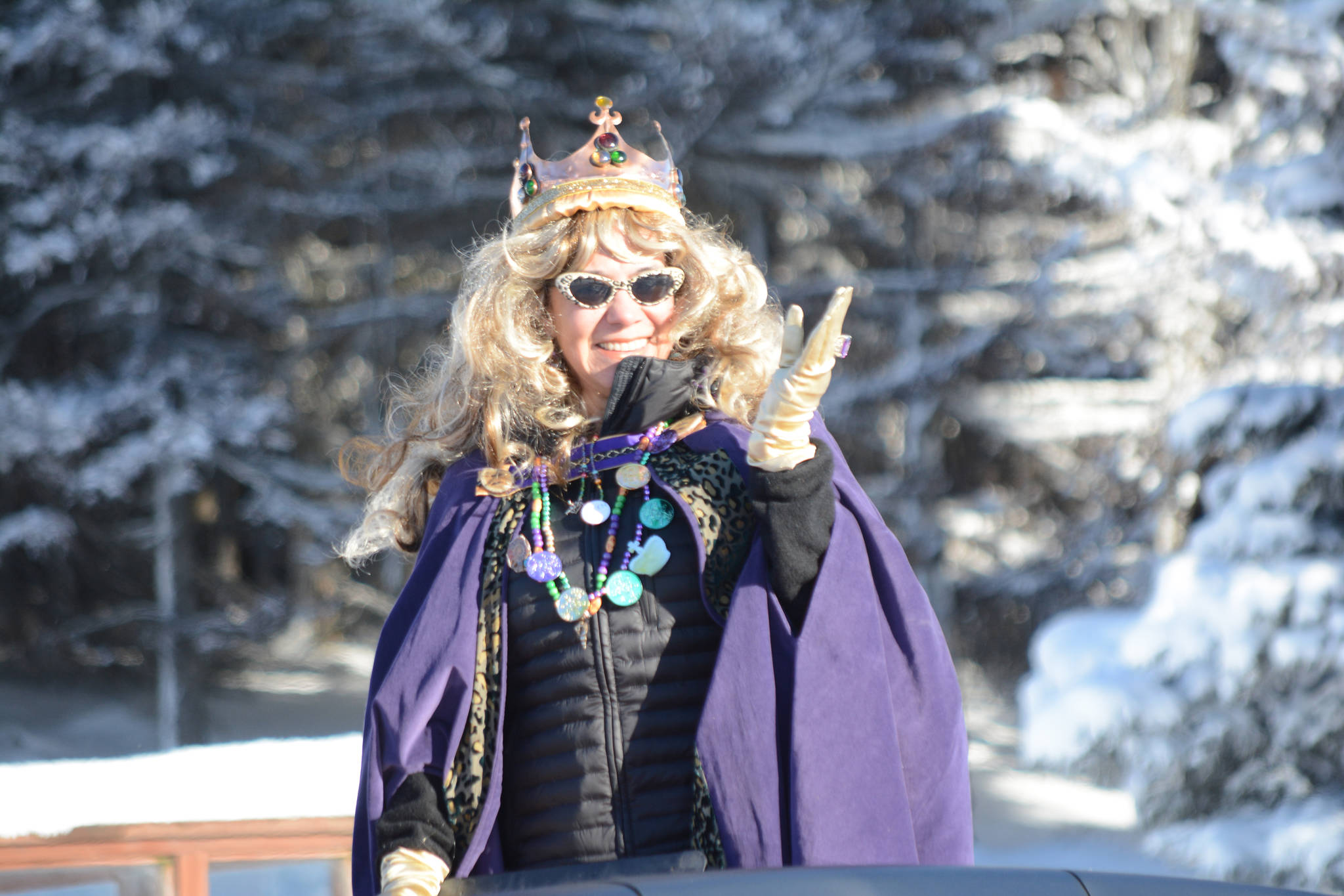 Parade Marshal Queen Krewe of Gambrinus Hilda Caraballo waves at the crowd at the 2017 Homer Winter Carnival Parade on Saturday. (Photo by Michael Armstrong, Homer News)