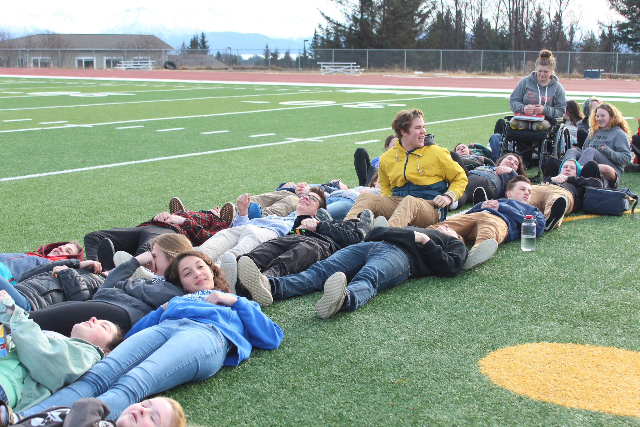 Students arrange themselves on Homer High School’s football field to form the number 17 during a walkout Wednesday, Feb. 21, 2018 in Homer, Alaska. Organizers said using their bodies to make the number was a way of honoring the people who died in the Valentine’s Day mass shooting in Parkland, Florida. (Photo by Megan Pacer/Homer News)
