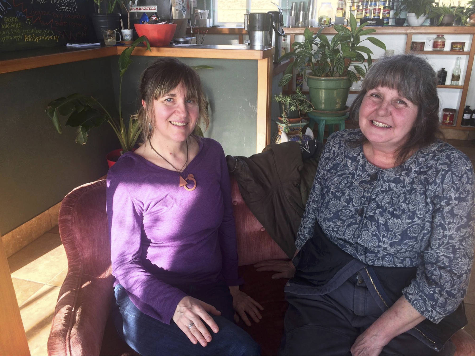 Shawn Zuke (left) and Anita Christie (right) sit on a couch during a planning session for the Homer ubuntu group at Stowaway Coffee on East End Road in Homer, Alaska. (Photo by Jennifer Tarnaki)