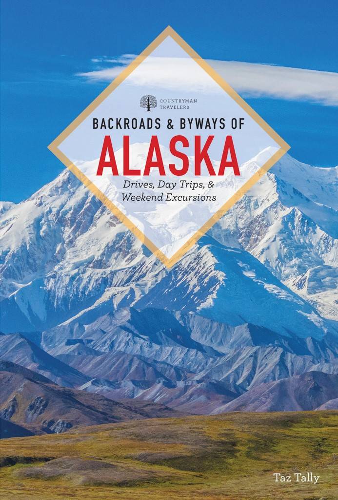 Taz Tally signs his new book, “Backroads & Byways of Alaska,” Friday at the Art Shop Gallery. (Photo provided)