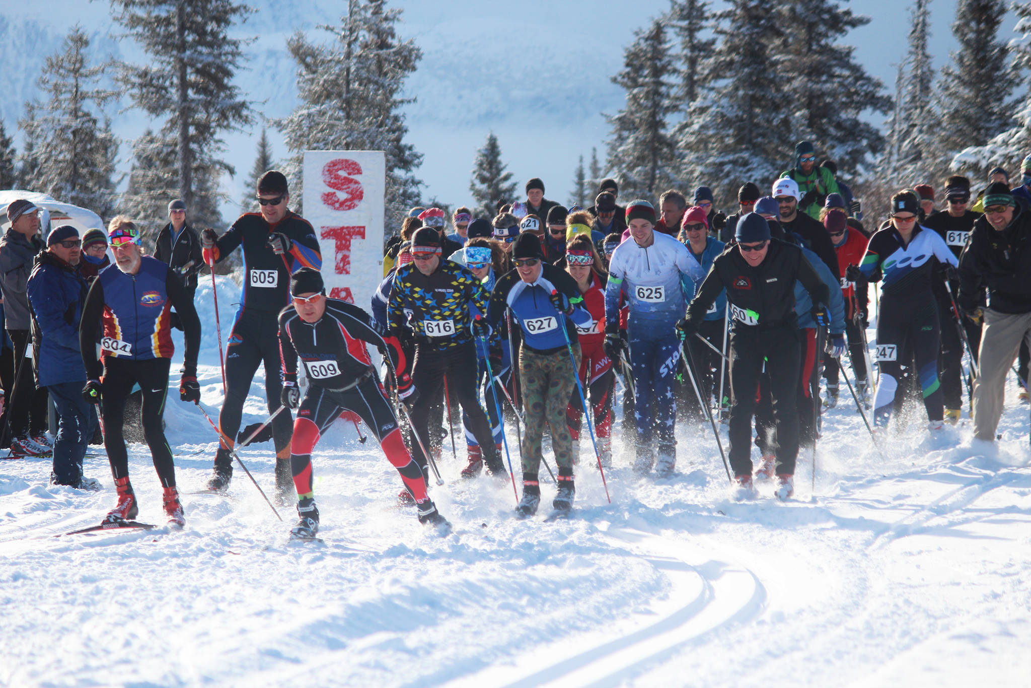 Skiers participating in the 42 Kilometer race take off from the starting line in this year’s Kachemak Bay Nordic Ski Marathon on Saturday, March 10, 2018 at the McNeil Canyon Ski Area outside of Homer, Alaska. (Photo by Megan Pacer/Homer News)