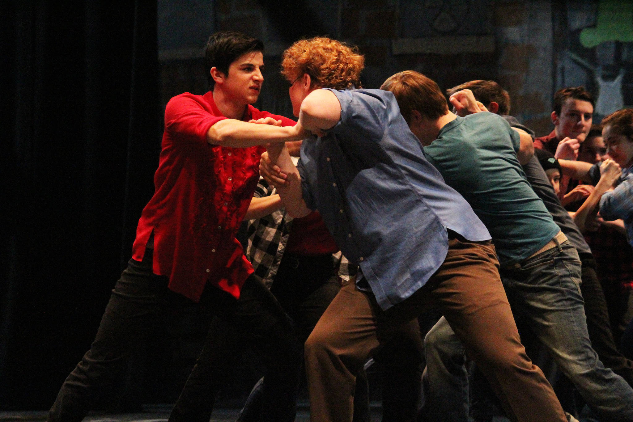 Homer High School students David Weisser (left) and Theodore Castellani (right) as the characters Bernardo and Riff, respectively act out a brawl scene from “West Side Story” during a dress rehearsal Tuesday, March 20, 2018 at the Mariner Theatre in Homer, Alaska. The musical is this year’s production for the school’s Concert Choir class, and and was last performed by the high school 15 years ago. (Photo by Megan Pacer/Homer News)