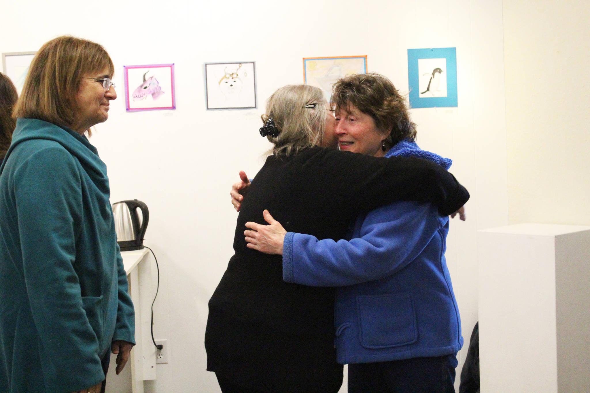 Darlene Hilderbrand gets a hug from a friend at a surprise party held to celebrate her retirement Sunday, March 18, 2018 at Homer Council on the Arts in Homer, Alaska. Hilderbrand worked at Homer of Hospice for 19 years. (Photo by Megan Pacer/Homer News)
