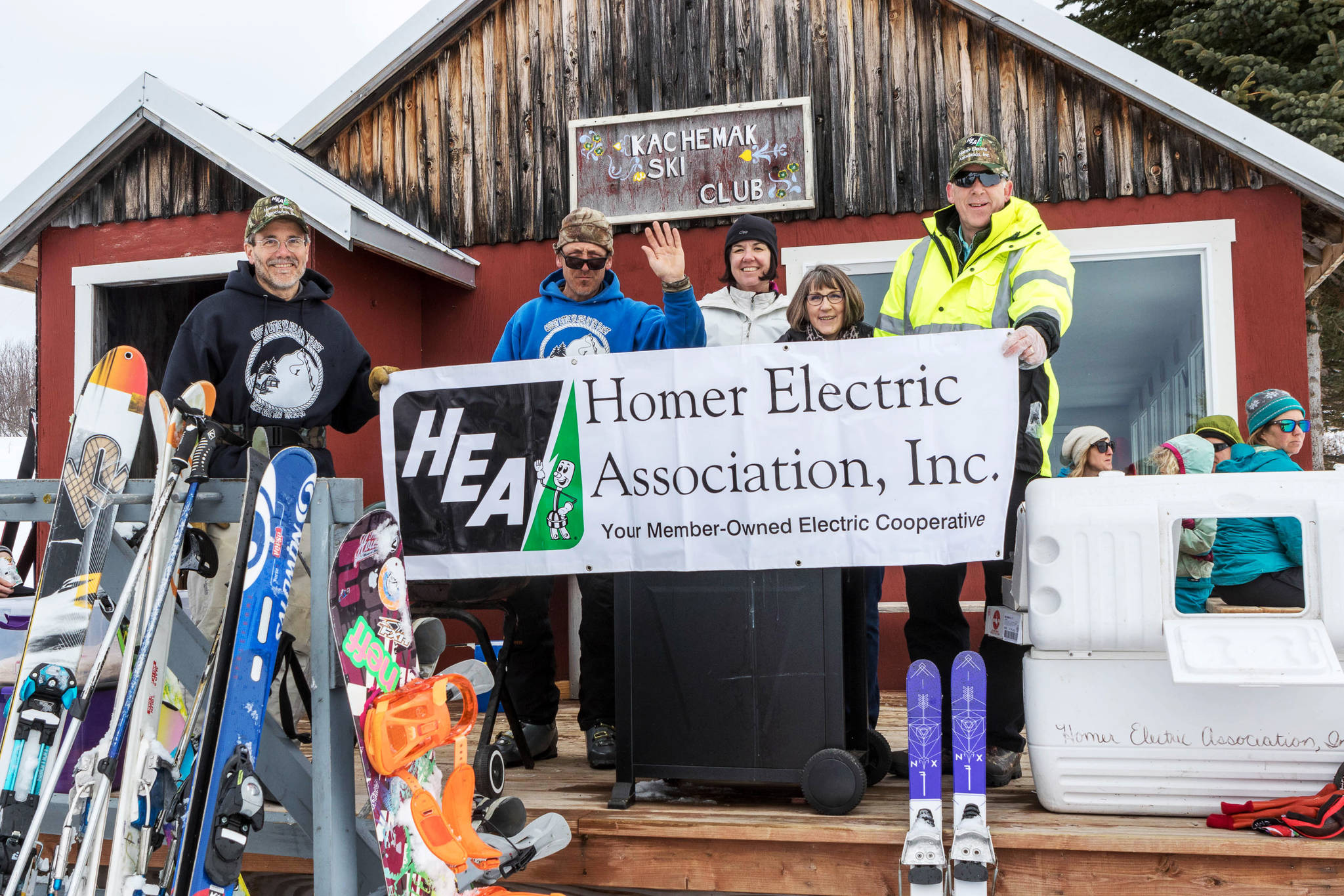 Kachemak Ski Club members on Sunday hold a Homer Electric Association banner for HEA Day at the Homer Rope Tow, Ohlson Mountain. HEA has been a longtime supporter of the club and rope tow. (Photo by Don Pitcher)