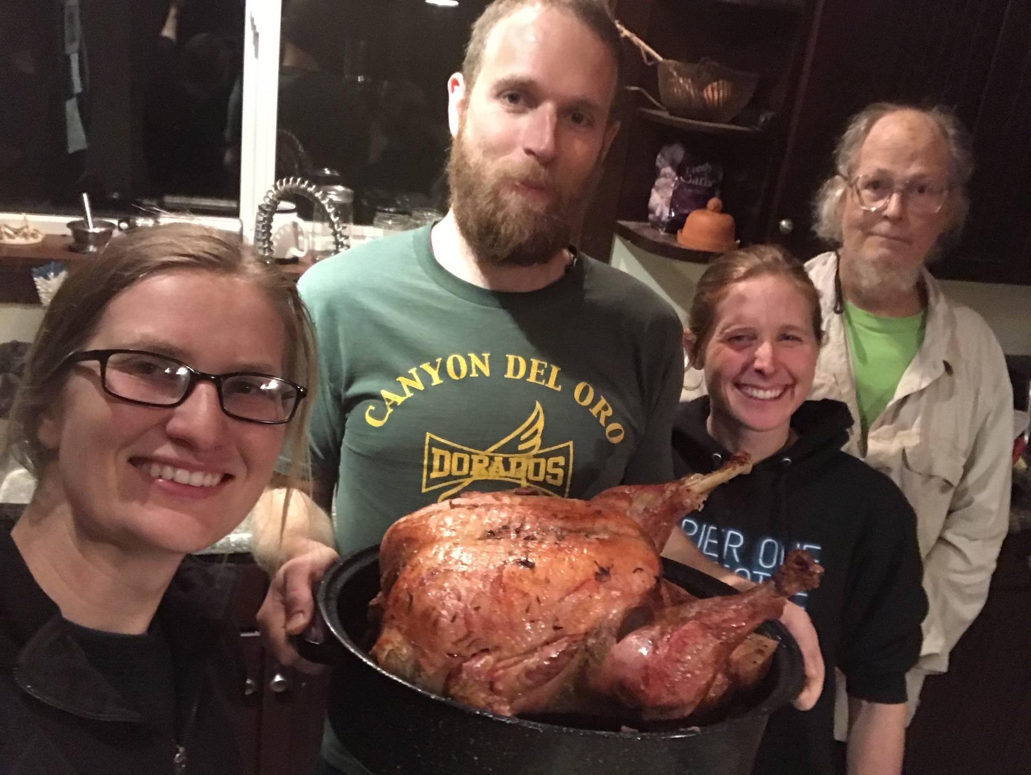 Blood, Sweat, and Food co-owner Beau Burgess, center, holds a turkey fresh from the oven. Next to him are co-owners Aryn Young, left, Jenni Medley, second from right, and Tony Burgess, far right. (Photo by Jennifer Tarnacki)
