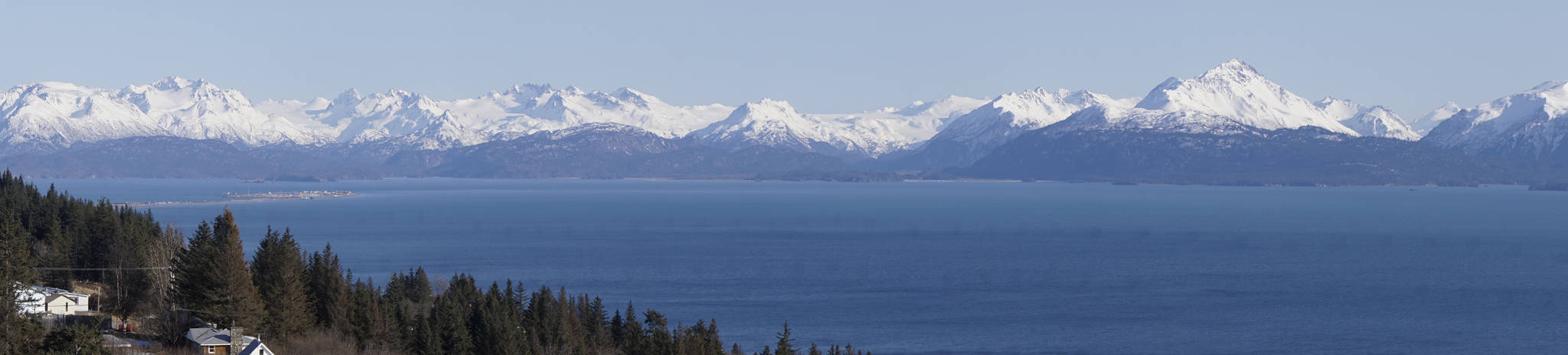 Why we live here, reason number 1 The Homer Spit and the Kenai Mountains glow in the later afternoon sun as seen from the Baycrest Hill turnout on Monday, April 2, 2018, in Homer, Alaska. The spectacular view off the Sterling Highway seen as people round the corner heading south has led to more than a few people settling in Homer. (Photo by Michael Armstrong/Homer News)