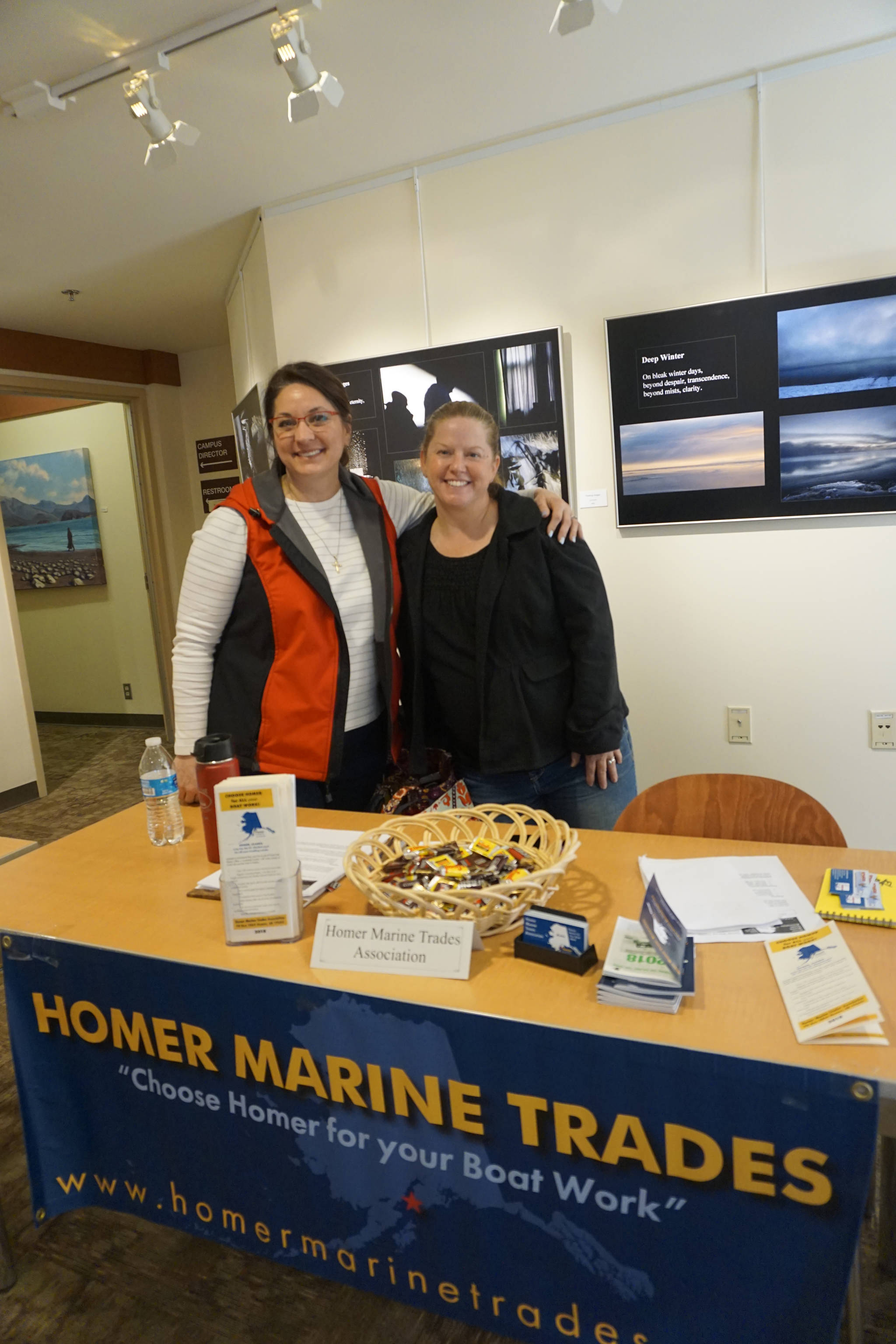 Cinda Martin, left, and Jennifer Mitchell Hakala, right, staff the Homer Marine Trades booth during the Kachemak Bay Campus College and Career Fair last Friday, March 30, 2018 in Homer, Alaska. About 400 students from 11 area schools as well as community members visited the annual event, said Kim Frost, KBC student and enrollment services coordinator. “Our focus is to get the younger people interested in training and employment,” Mitchell Hakala said. (Photo by Michael Armstrong/Homer News)