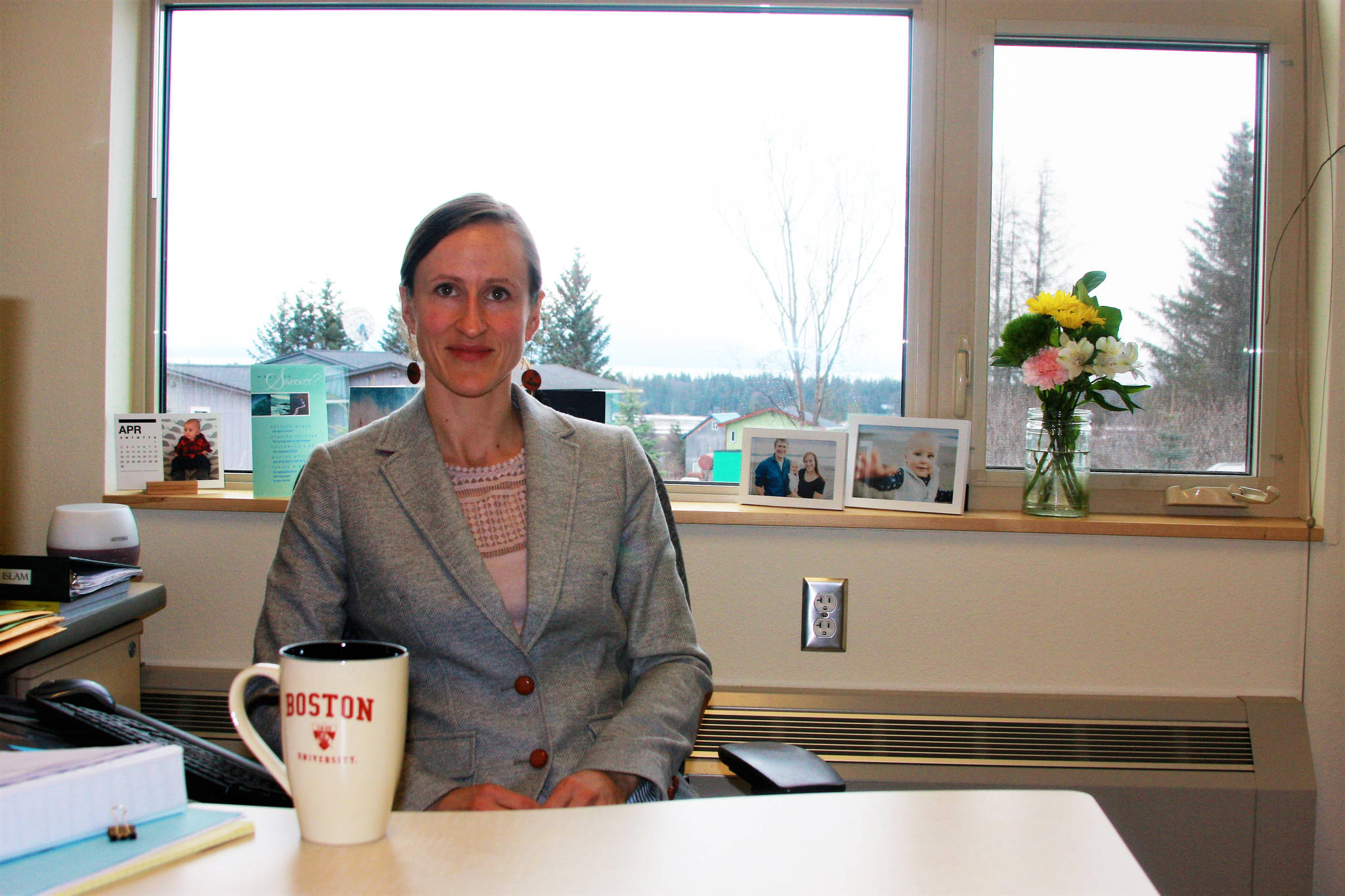 Assistant Professor of English Lia Calhoun poses in her office in Bayview Hall on Wednesday, April 4, 2018 at Kachemak Bay Campus in Homer, Alaska. (Photo by Delcenia Cosman)