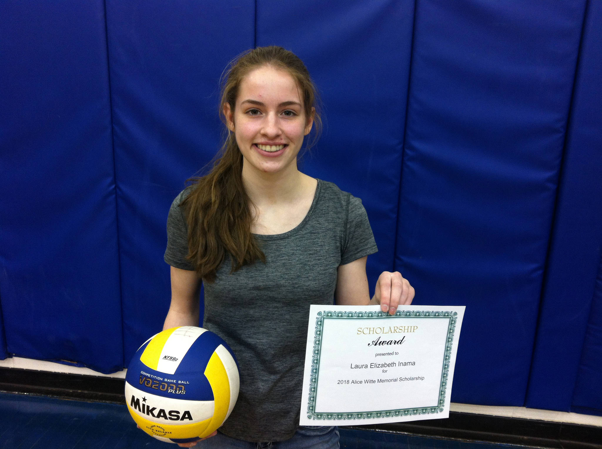 Photo provided Homer freshman and volleyball player Laura Inama holds her Alice Witte Memorial Volleyball Scholarship award.