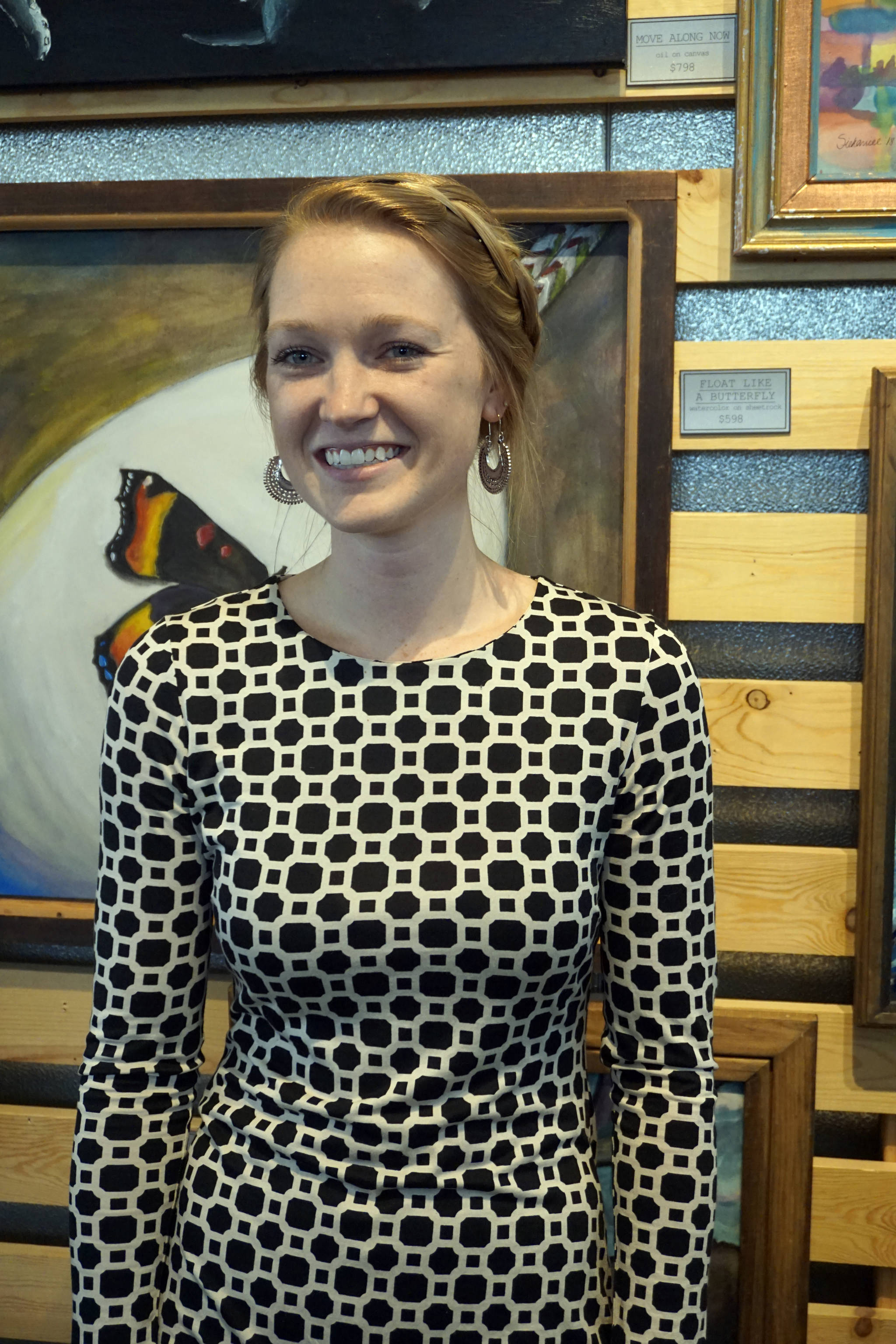 Britni Siekaniec stands by one of her paintings at the First Friday opening of her show, “Salt,” at Grace Ridge Brewery on April 6, 2018, in Homer, Alaska. (Photo by Michael Armstrong, Homer News)
