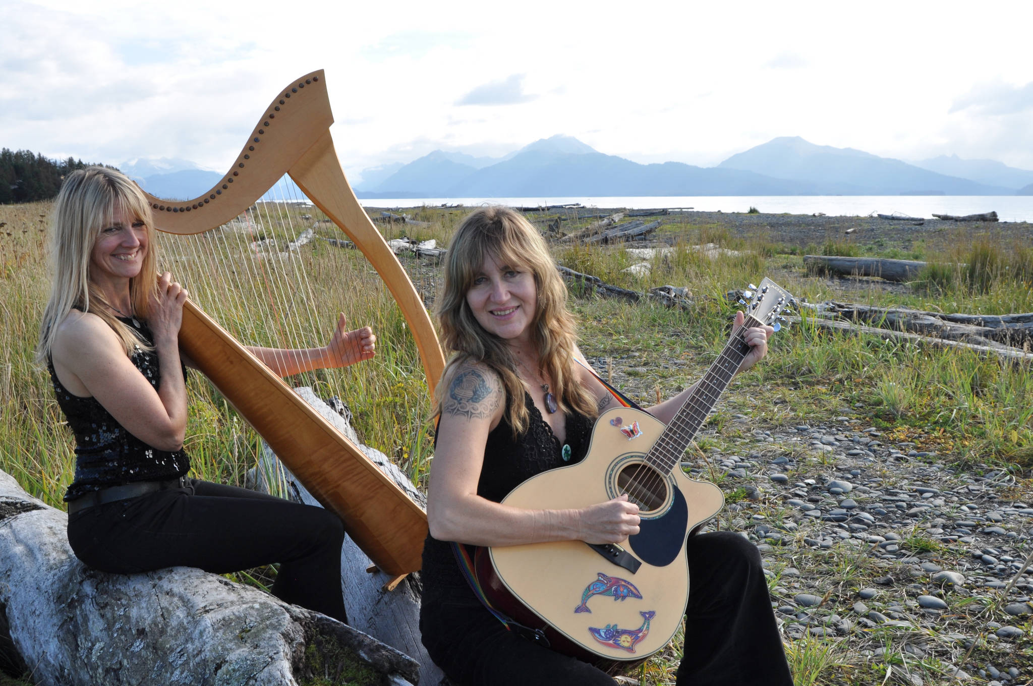 Michelle Morton, left, and Shawn Zuke, left, play harp and guitar at Bishop’s Beach, Homer, Alaska. (Photo by Tim Steinberg)