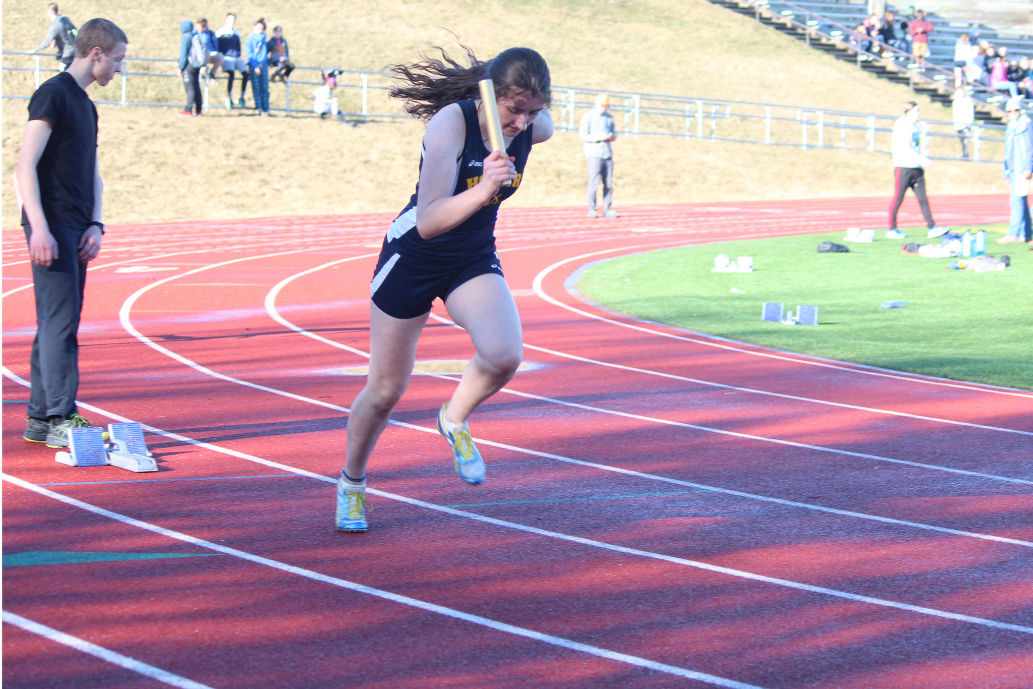 Homer’s Marina Carroll takes off from her blocks as the first leg of the girls’ 1,600-meter relay Friday, April 13, 2018 at Homer High School in Homer, Alaska. The Homer High track and field team faced off against Soldotna High School in a dual meet. (Photo by Megan Pacer/Homer News)