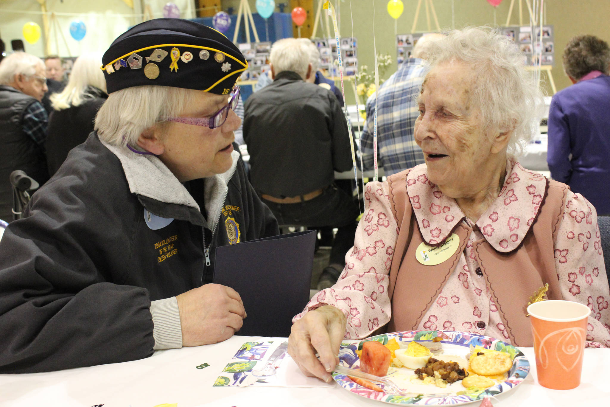 Photo by McKibben Jackinsky Eileen Faulkner, left, of American Legion Post 16 in Homer visits with Wilma Gregory of Homer, right, who turned 100 on Saturday.