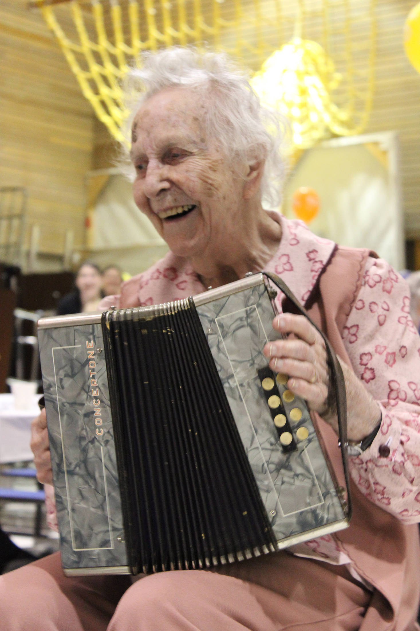 Wilma Gregory celebrates her 100th birthday Saturday by serenading family and friends to “Mockingbird Hill” played on her accordion. The celebration was held at McNeil Canyon School. (Photo by McKibben Jackinsky)