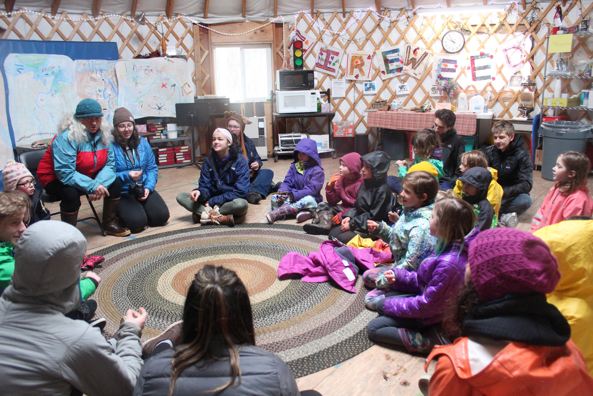 A group of Little Fireweed and Homer High School students talk about their morning together learning about the outdoors with teacher Kim Fine on Tuesday, April 24, 2018 at the school in Homer, Alaska. (Photo by Megan Pacer/Homer News)