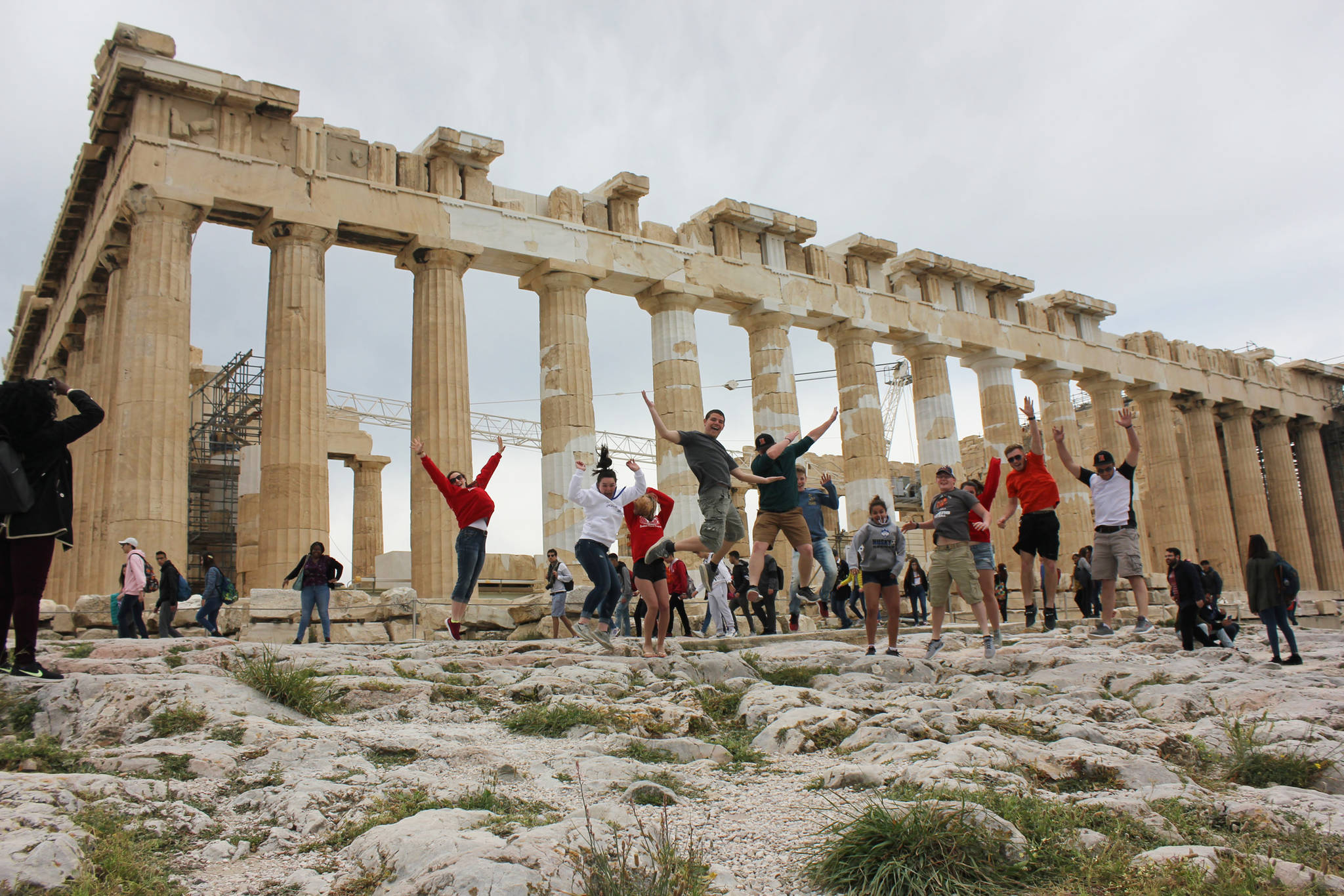 Students from Michigan and Homer jump for joy during their recent trip to Greece in April. (Photo provided)