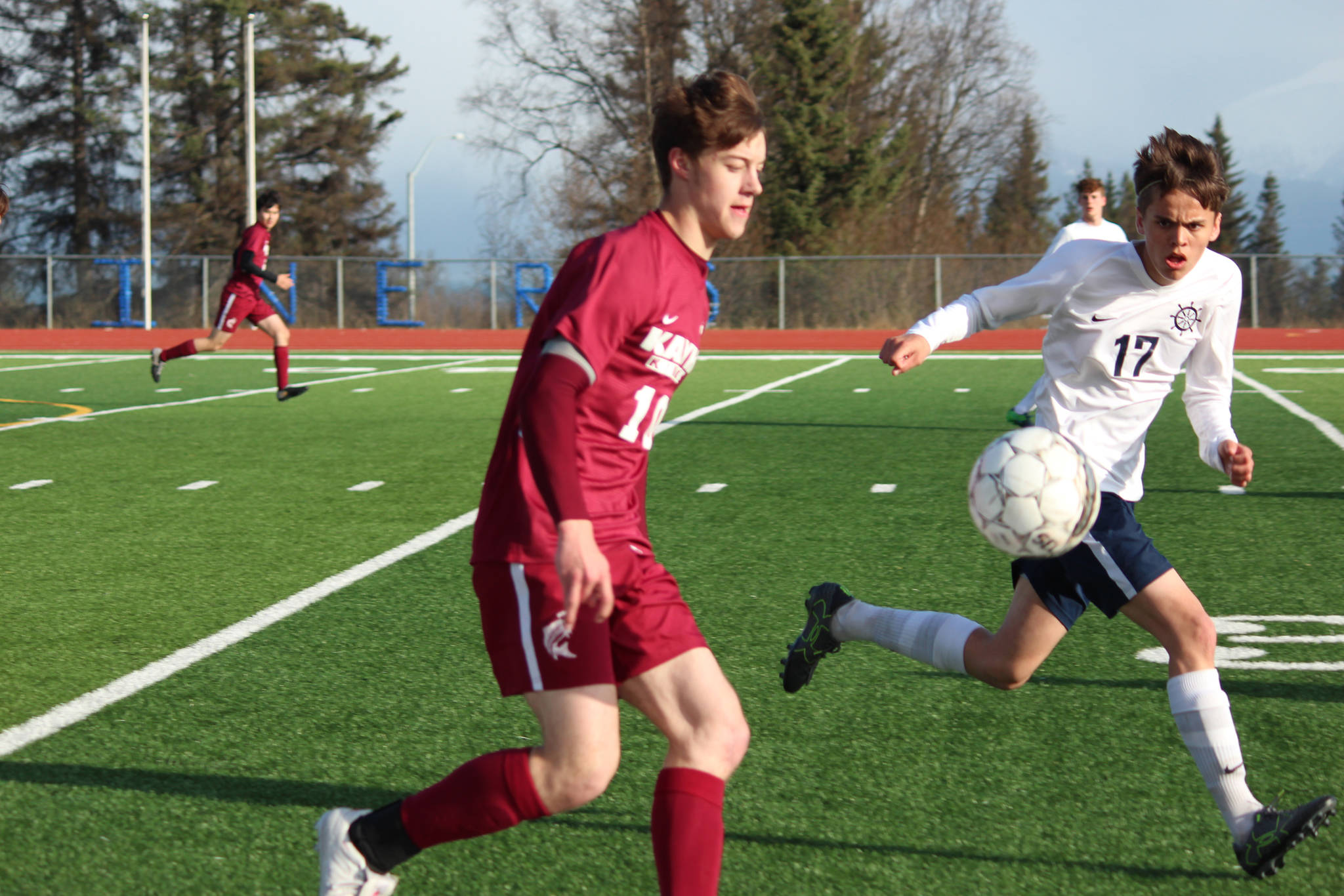 Ketchikan’s Henning Pankow steadies the ball while Homer High School’s Isaiah Nevak looks for a way to intercept during their match Friday, May 4, 2018 in Homer, Alaska. Ketchikan won the match 1-0. (Photo by Megan Pacer/Homer News)