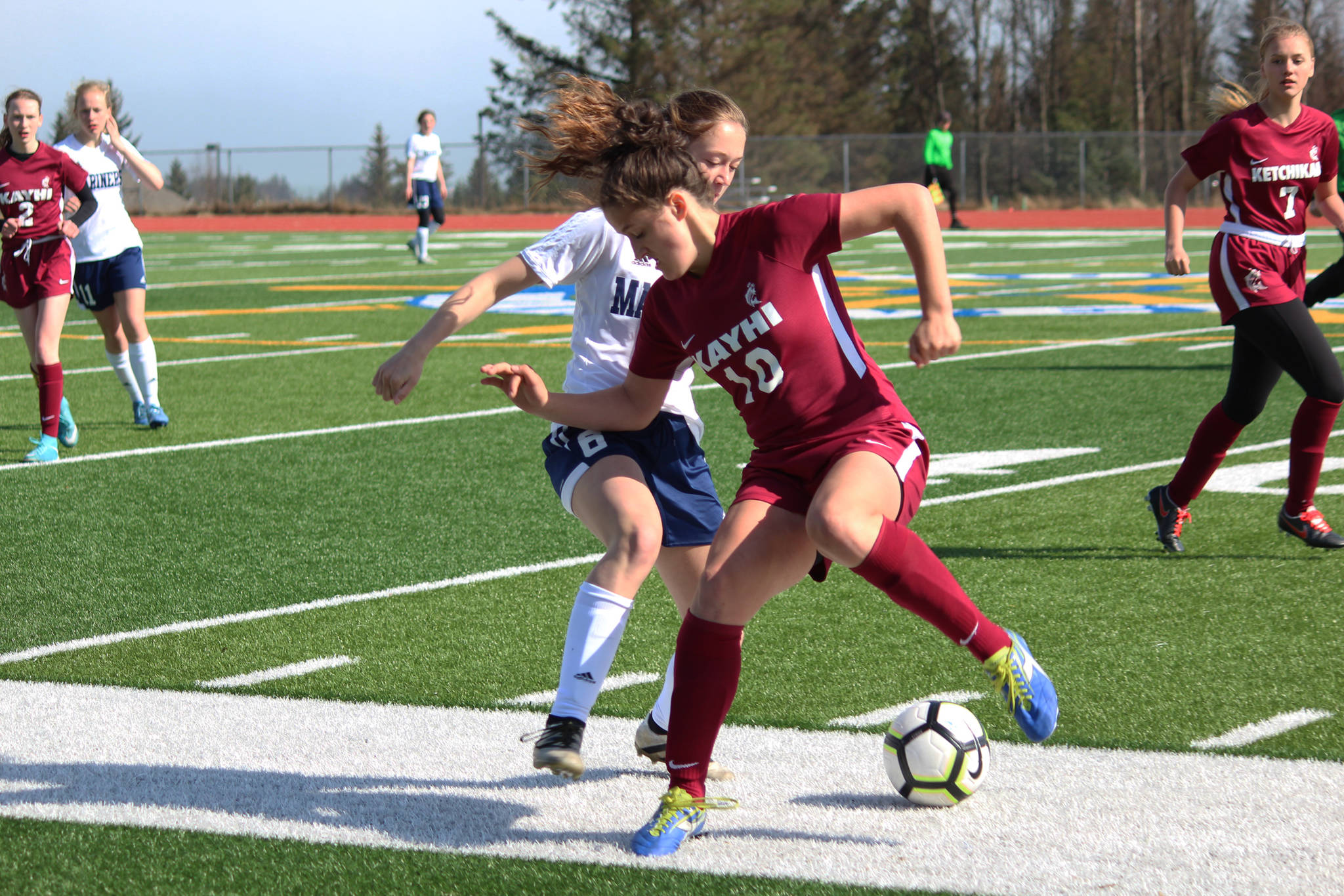 Ketchikan’s Collette Rhein tries to keep the ball away from Homer’s Eve Brau during their game Friday, May 4, 2018 at Homer High School in Homer, Alaska. Ketchikan won the match 2-1. (Photo by Megan Pacer/Homer News)