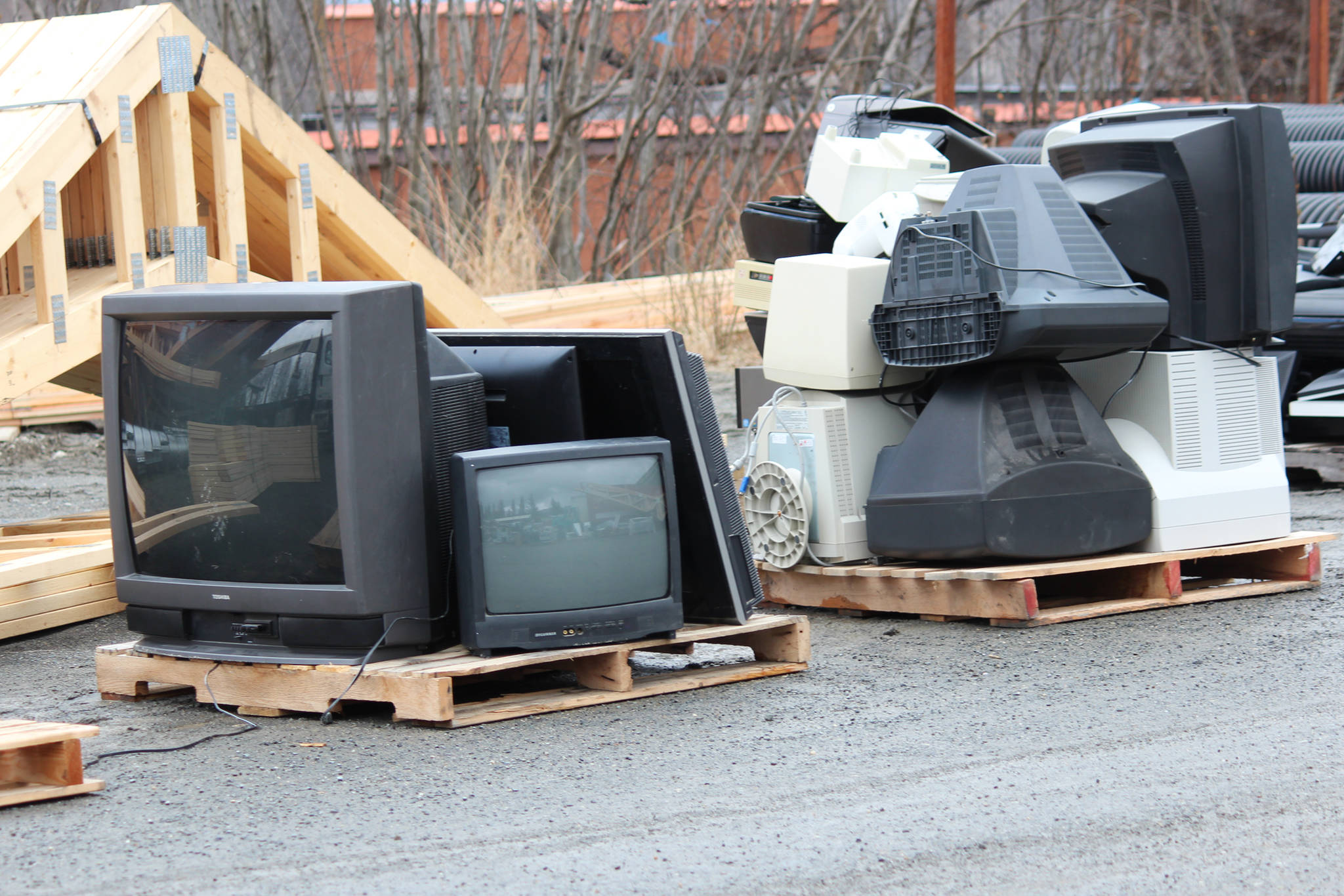 Old television sets rest on pallets during Cook Inletkeeper’s annual electronic recycling event Saturday, May 5, 2018 behind Spenard Builders Supply in Homer, Alaska. Television sets, especially older ones, are important to recycle because they contain substances like mercury that are harmful to the environment. (Photo by Megan Pacer/Homer News)