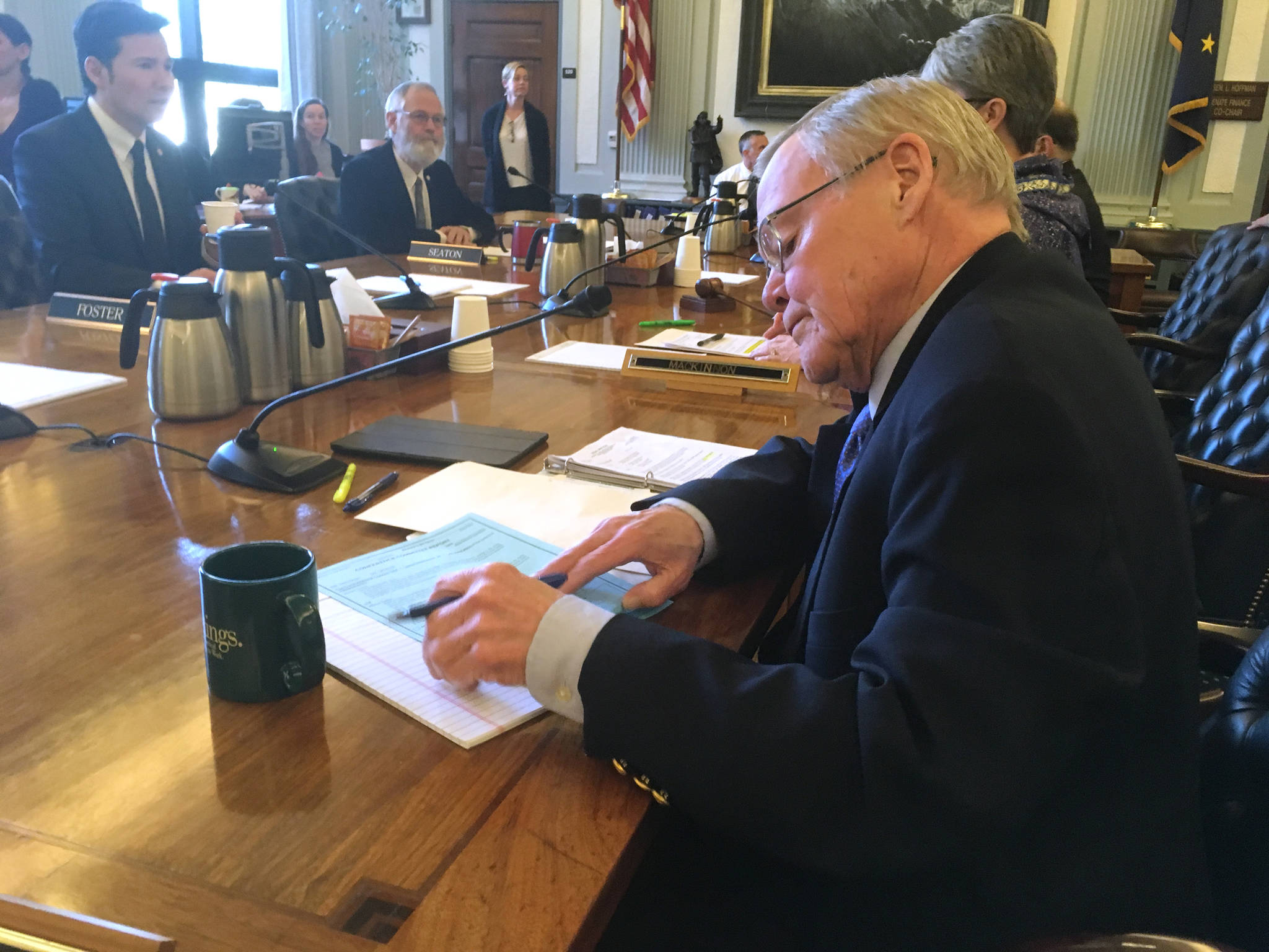 Sen. Dennis Egan, D-Juneau, signs the conference committee report on Senate Bill 26 on Tuesday, May 8, 2018. (James Brooks